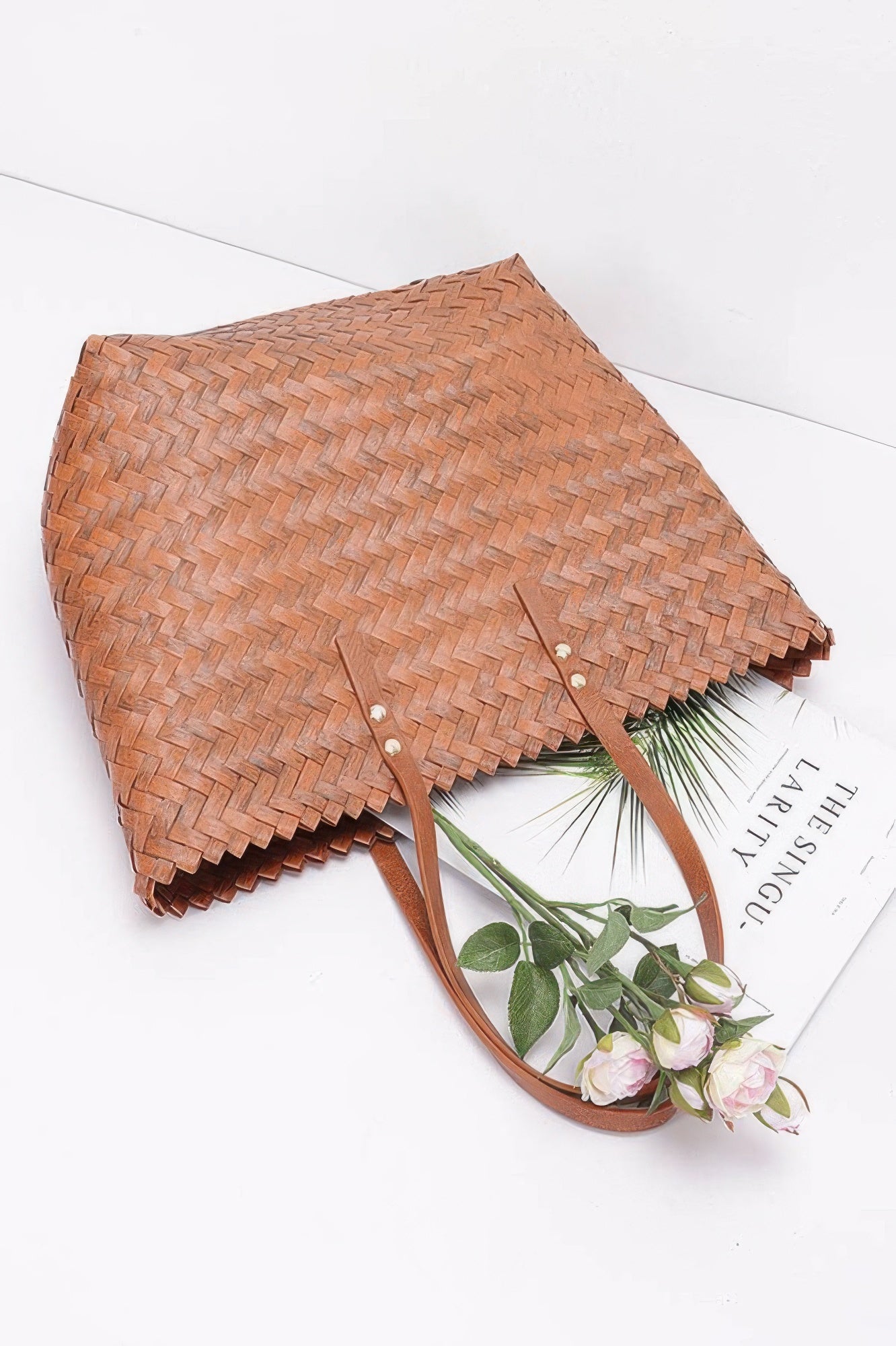 Brown PVC braided tote with front snap buttons and woven braided texture