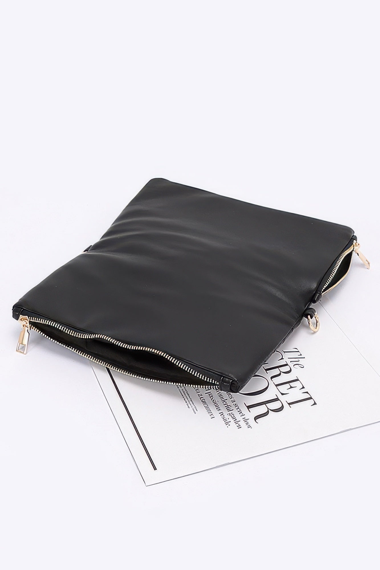 Quilted faux leather half-fold clutch, dark faux leather side view with gold zipper pull