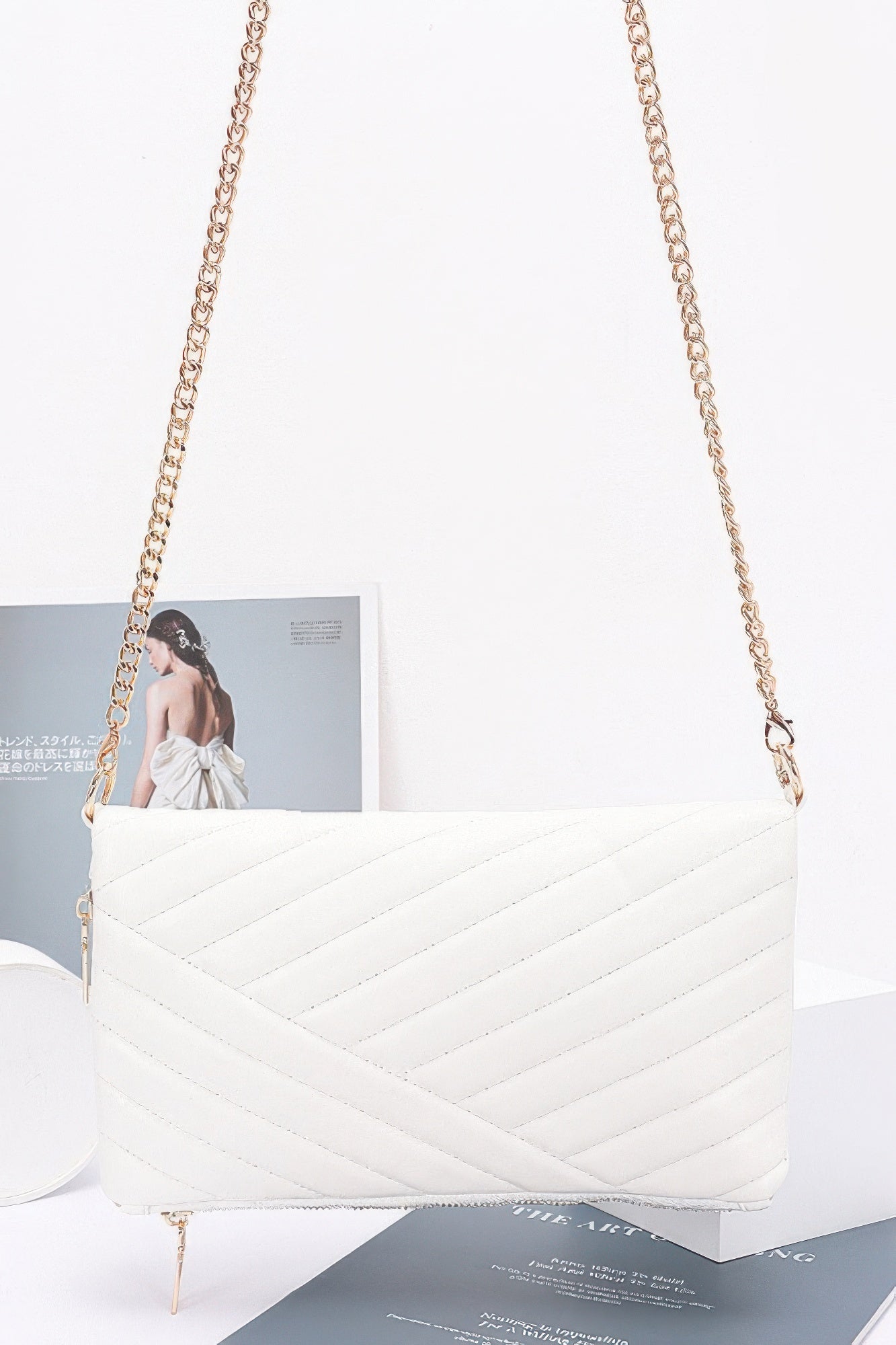 Quilted faux leather shoulder clutch, white with chain strap and gold zipper detail