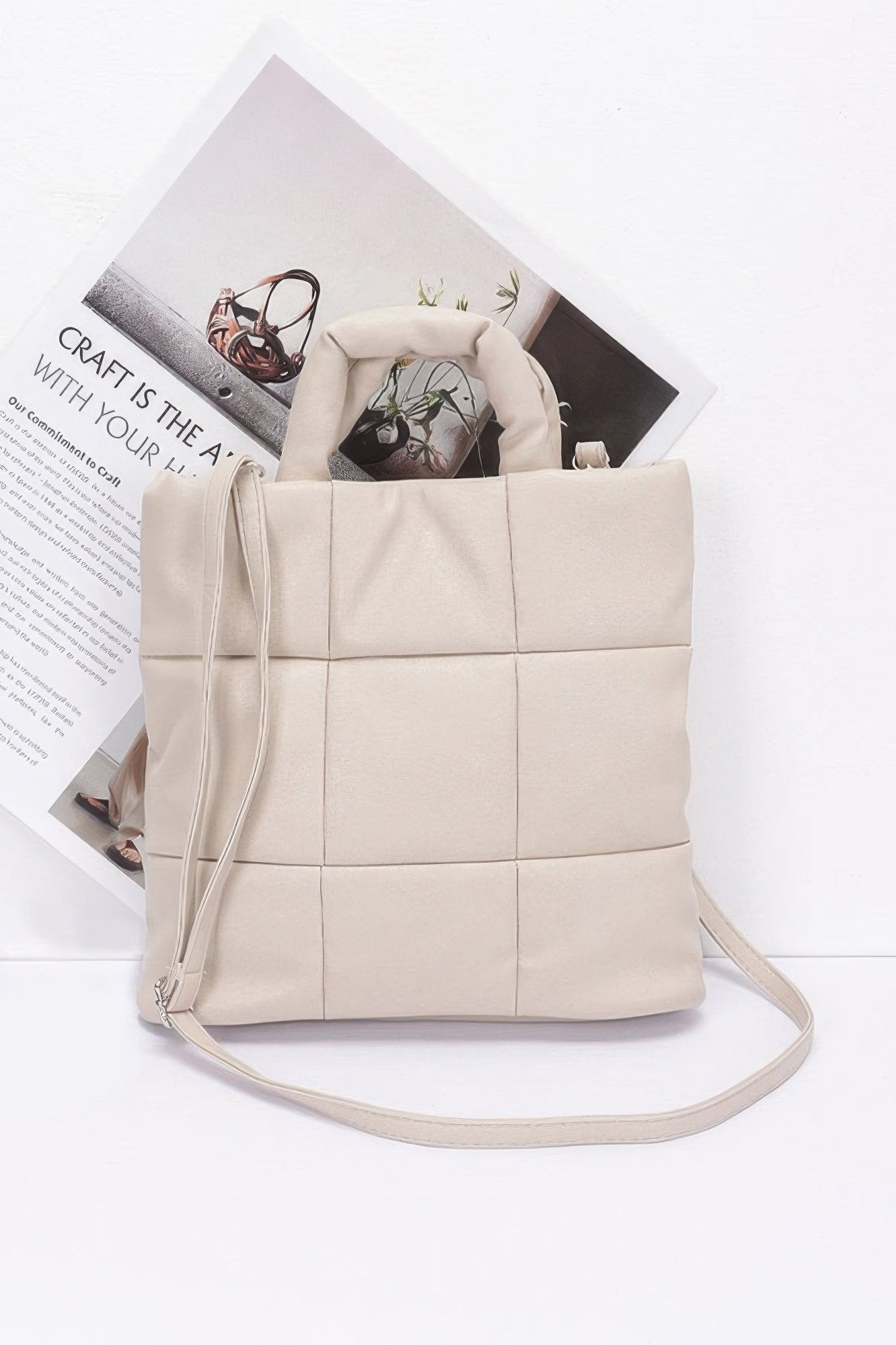 Beige quilted faux leather padded tote bag with top handles and crossbody strap