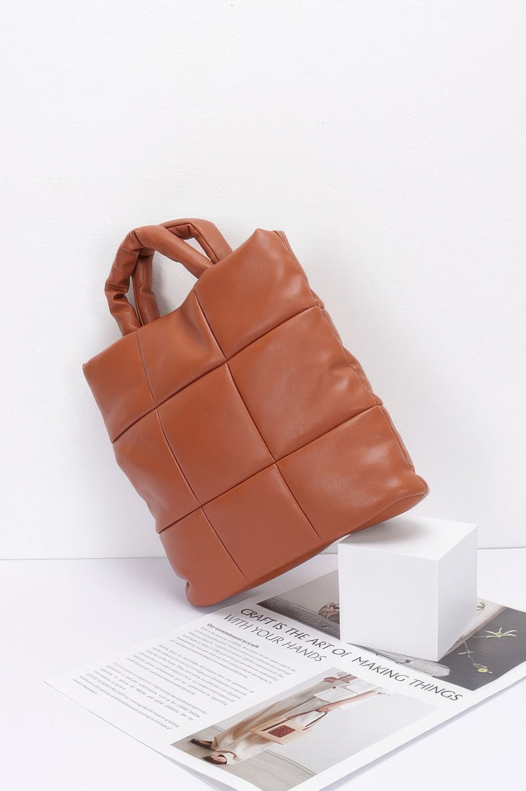 Camel quilted faux leather padded tote bag angled view with top handles