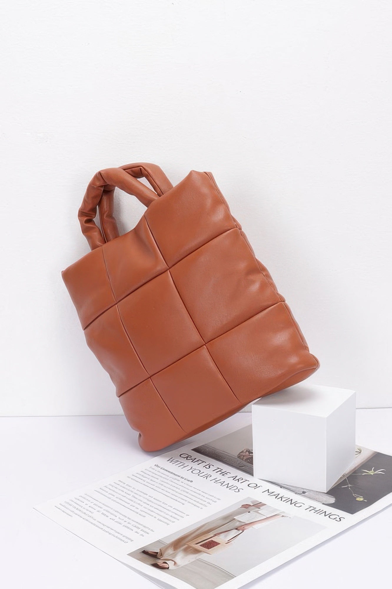 Camel quilted faux leather padded tote bag angled view with top handles