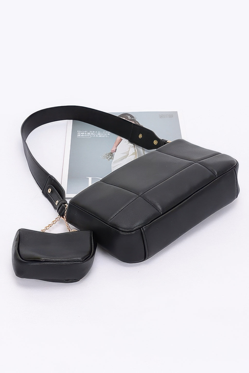 Black quilted bag with curved top handle, zip detail, and attached small AirPods pouch