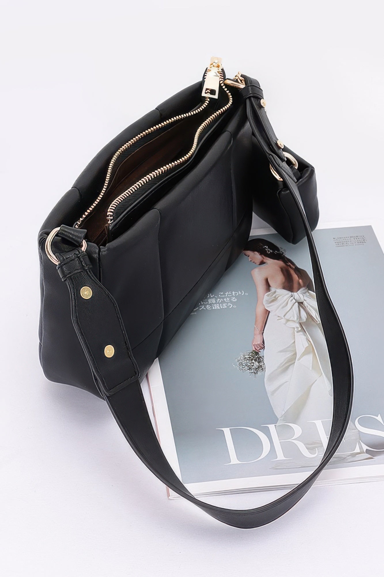 Black quilted shoulder bag open view with inner zipper and removable small pouch