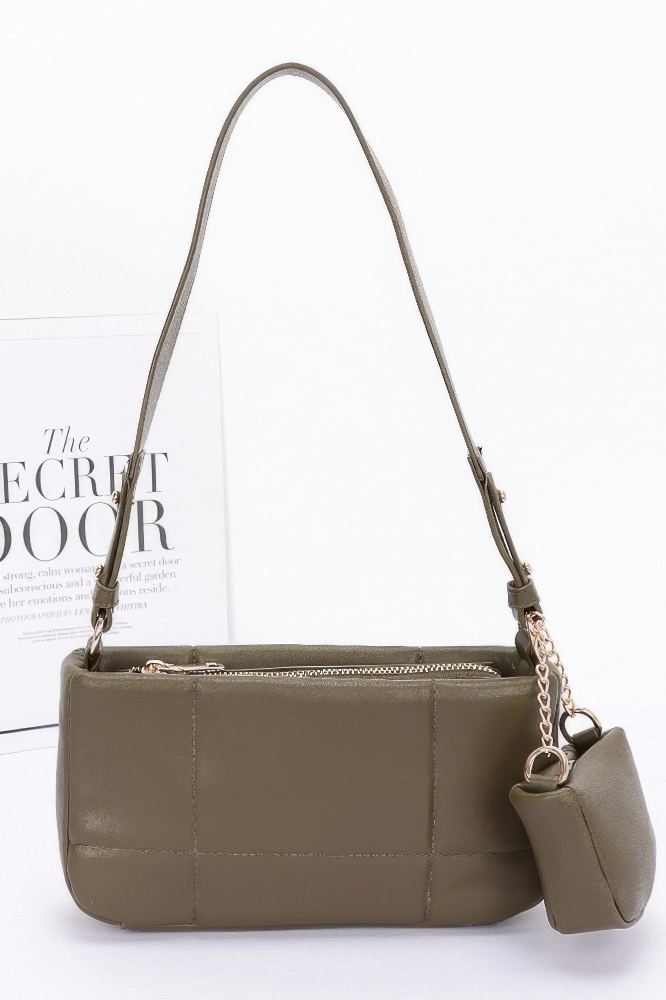 Olive quilted shoulder bag with chain strap and attached small AirPods pouch