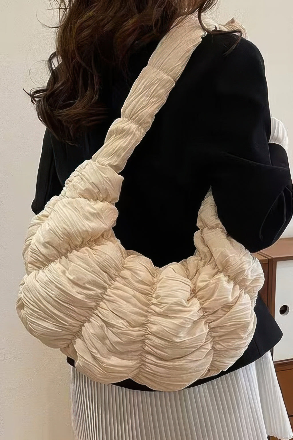 Beige quilted nylon padded crossbody bag with ruched texture and shoulder strap