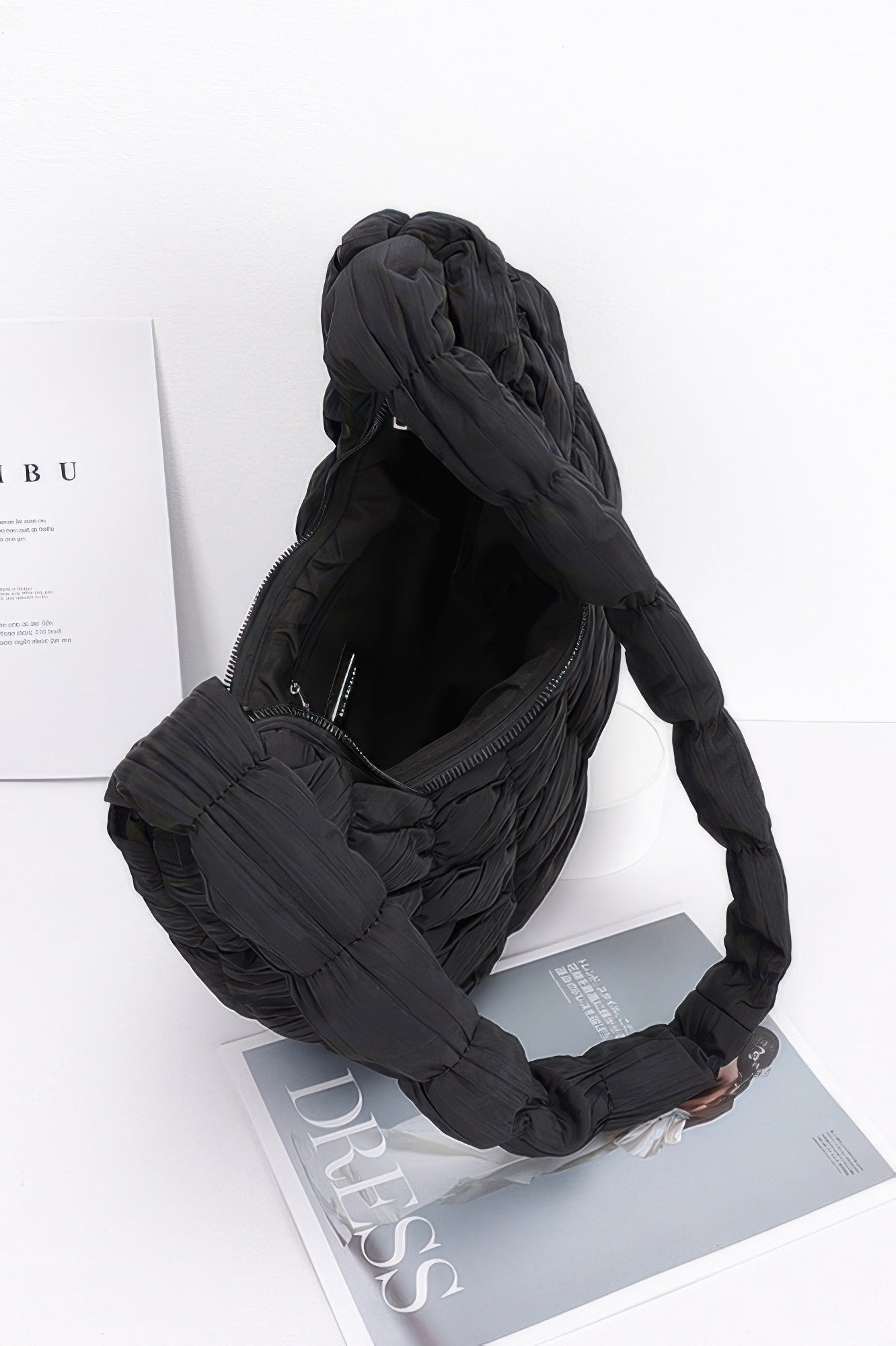 Black quilted nylon padded crossbody bag with zip top and interior pocket