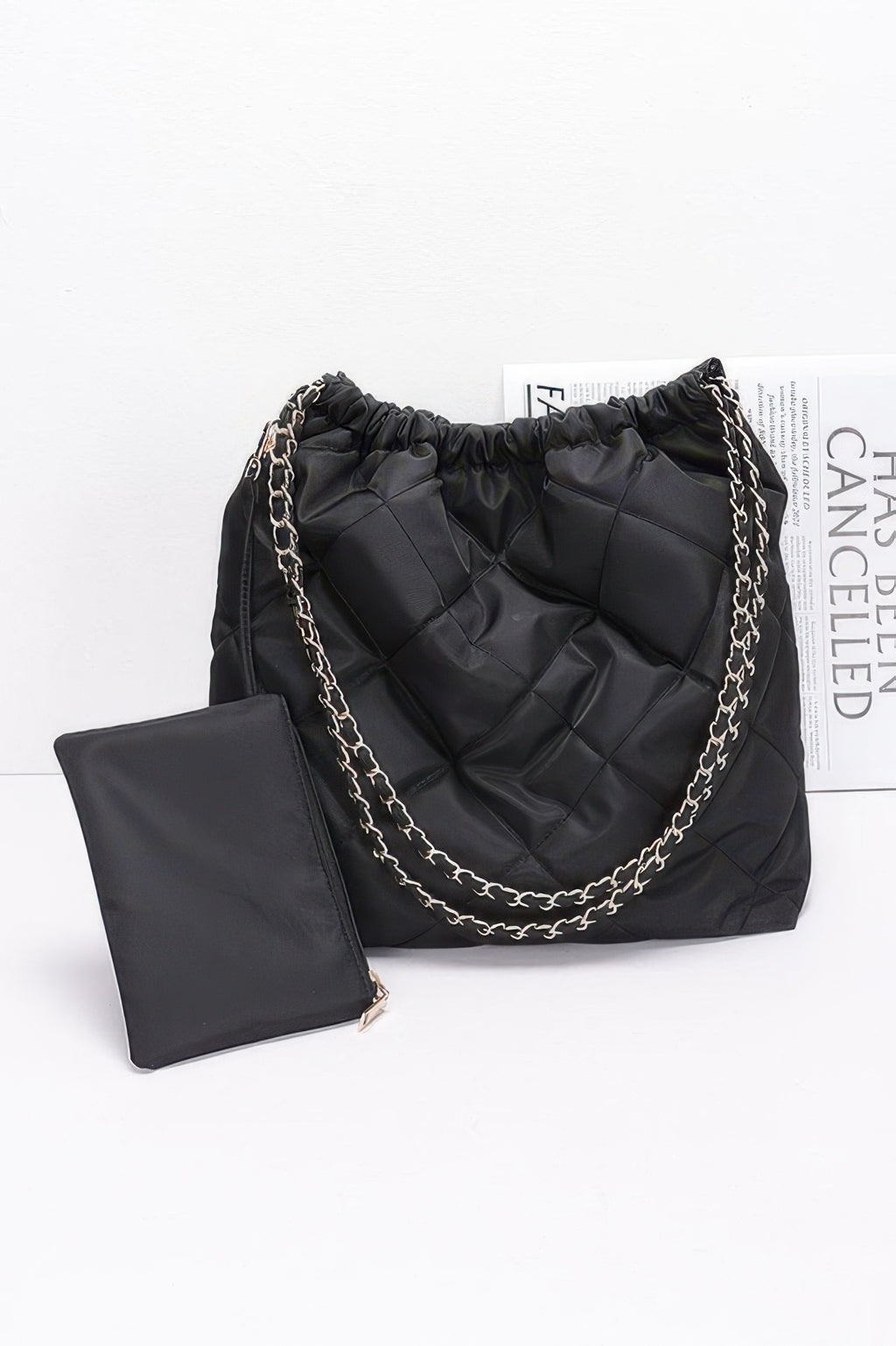 Black quilted nylon shoulder bag with metal chain and gathered top, plus card pouch