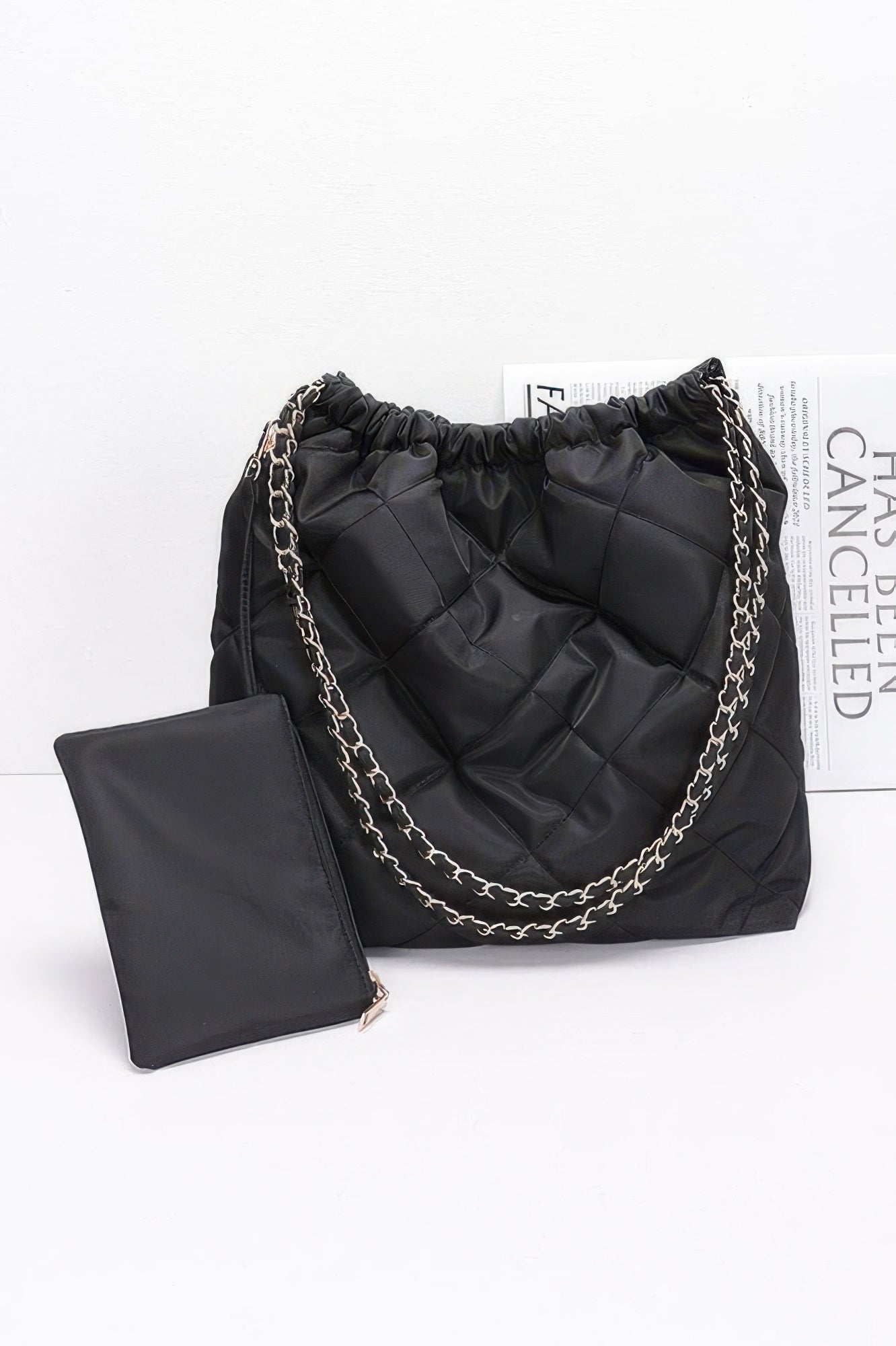 Black quilted nylon shoulder bag with metal chain and gathered top, plus card pouch