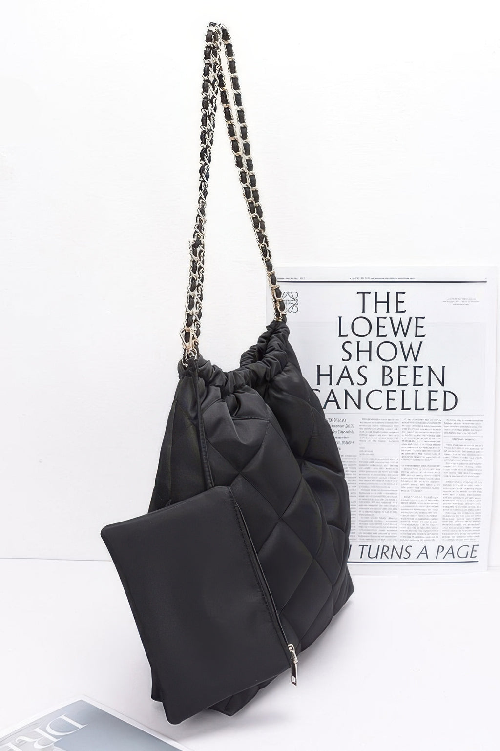 Black quilted shoulder bag with long metal chain strap and matching small pouch