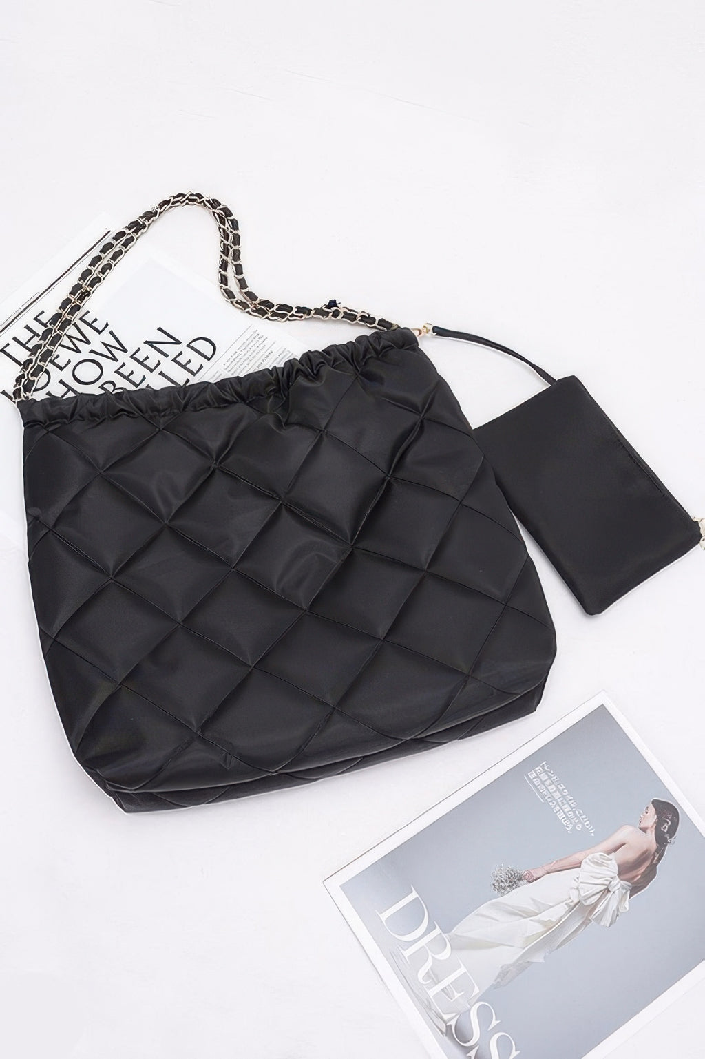 Black quilted shoulder bag with chain handle, ruched top, and detachable small pouch