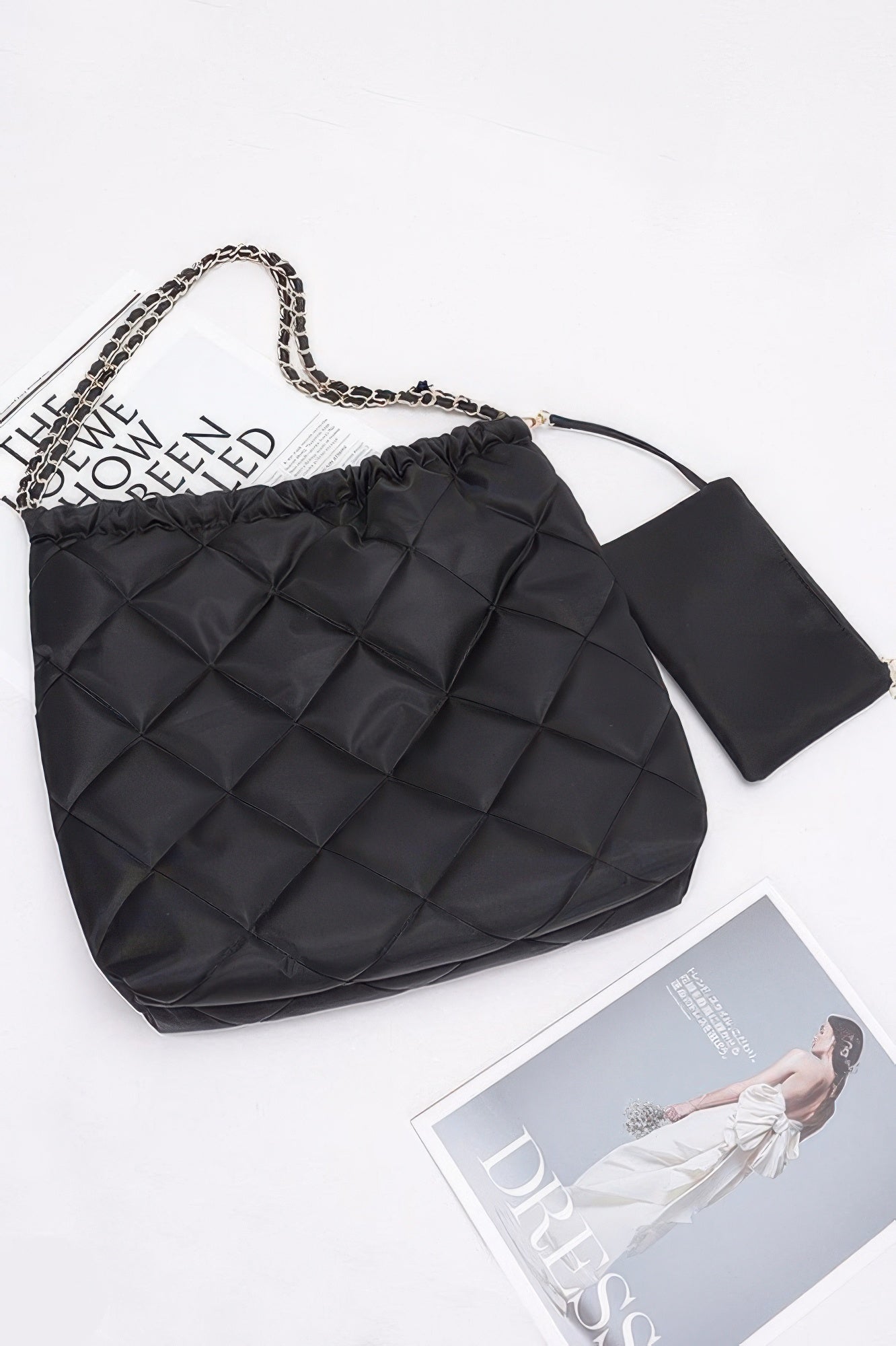 Black quilted shoulder bag with chain handle, ruched top, and detachable small pouch