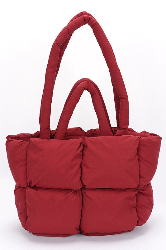 Burgundy quilted puffer convertible tote bag with two handles and structured padded base