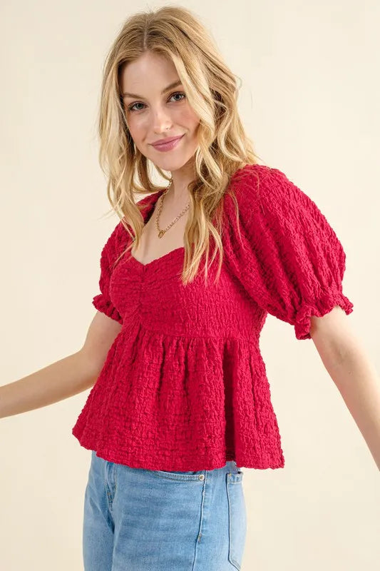 Red smocked blouse top with square neckline and gathered peplum waist