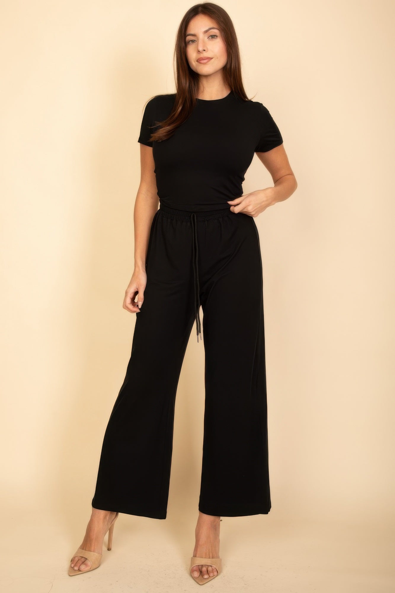 Black short-sleeve crew-neck top with wide-leg pull-on pants and elastic drawstring waist