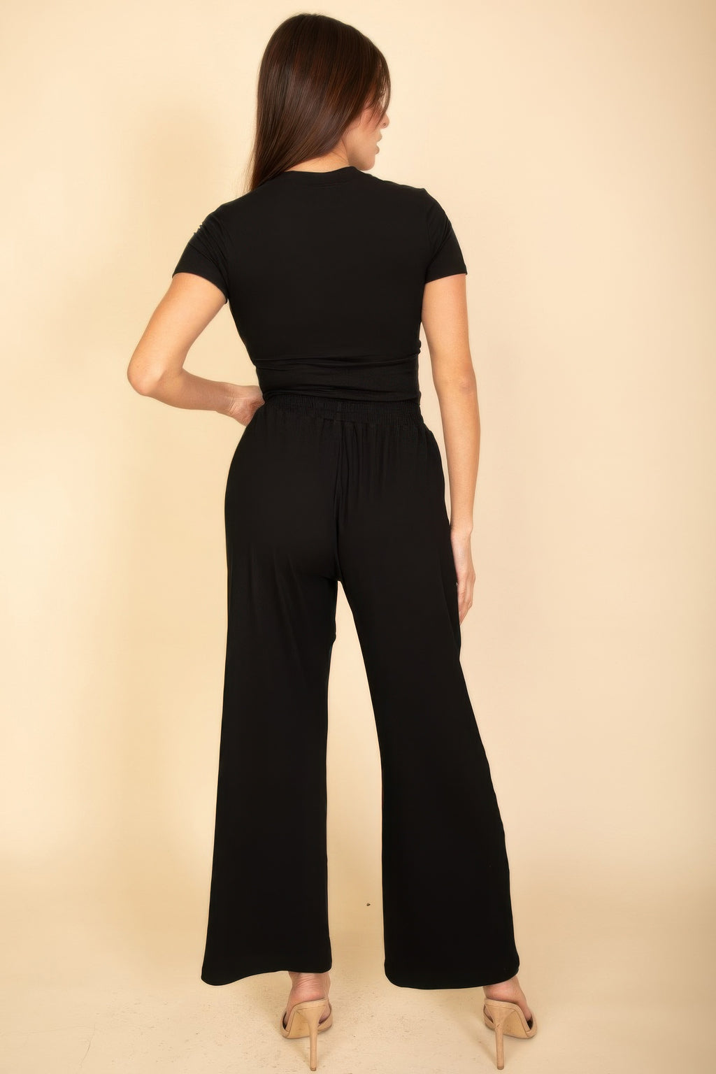 Black back view of wide-leg pants with elastic waist and drawstring, relaxed top