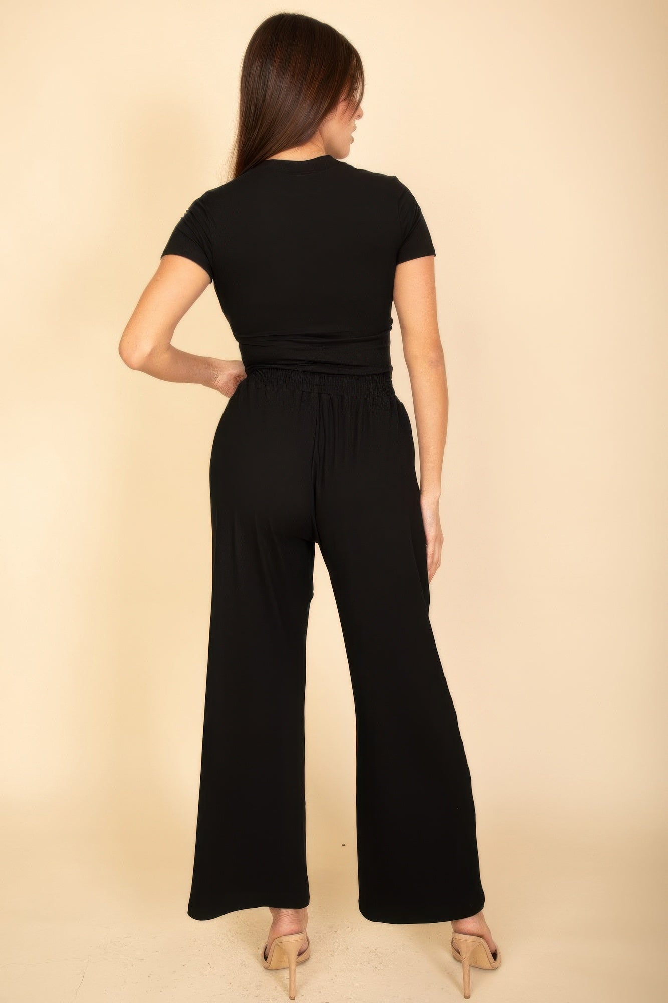 Black back view of wide-leg pants with elastic waist and drawstring, relaxed top