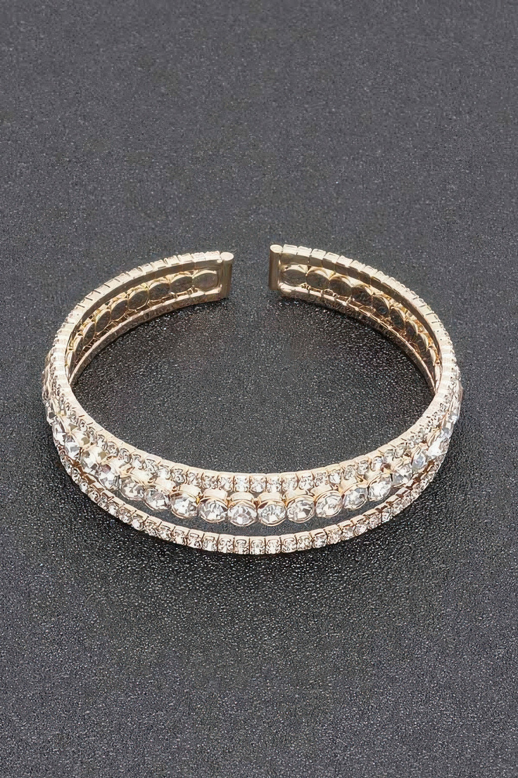 Rhinestone bracelet with silver-toned setting and clear stones, hinged cuff