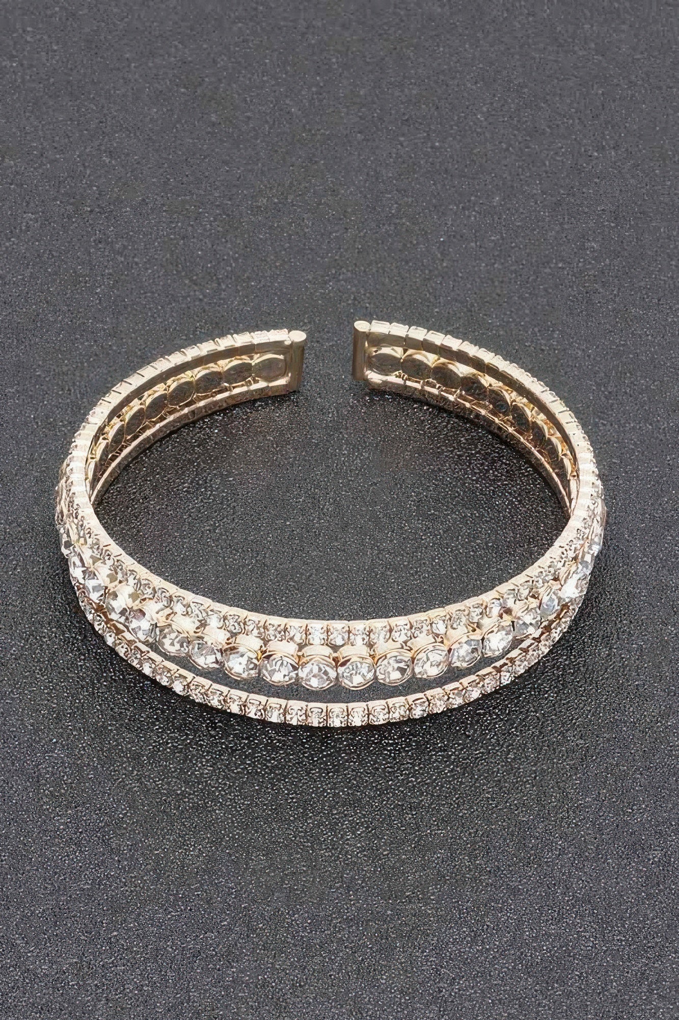 Rhinestone bracelet with silver-toned setting and clear stones, hinged cuff