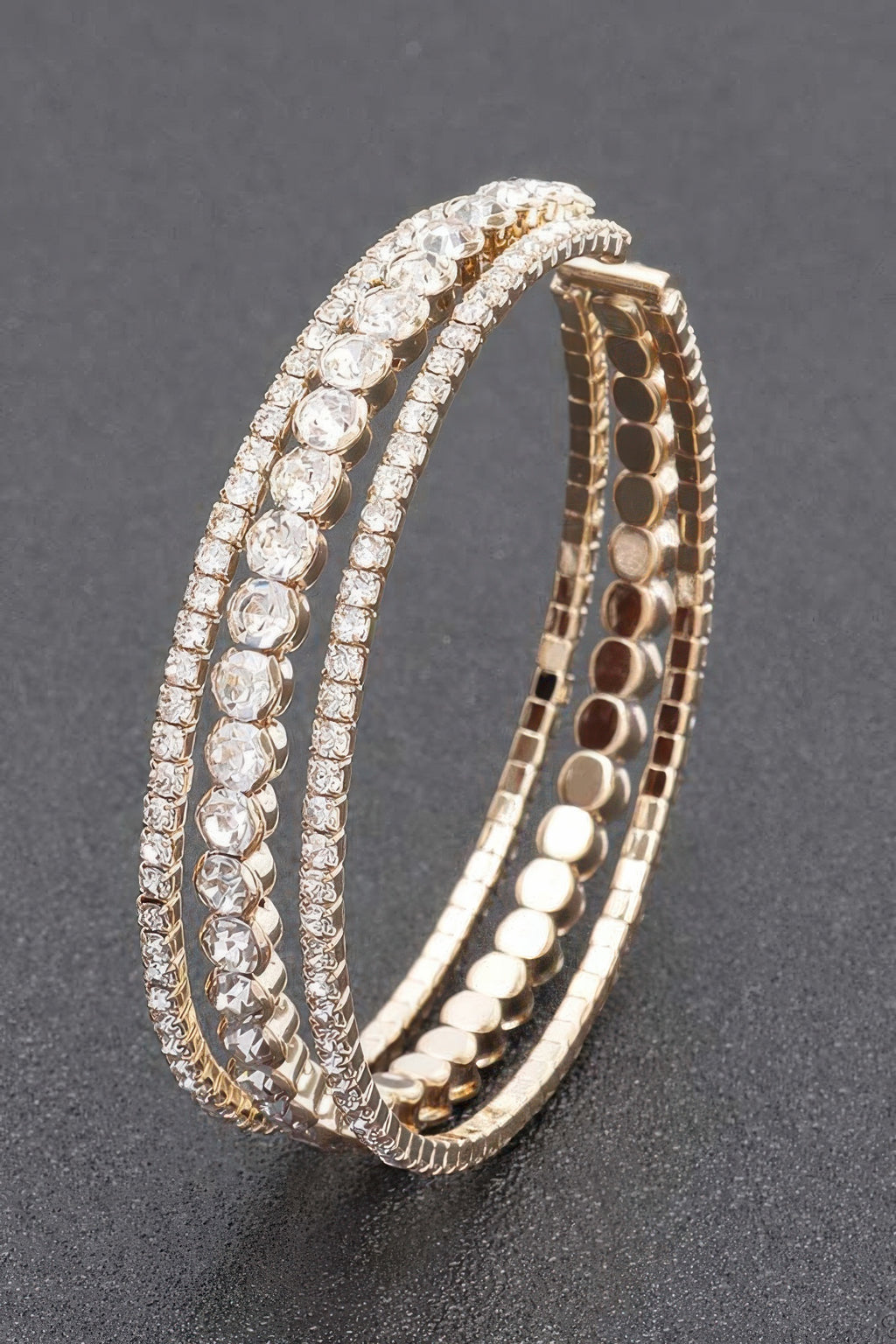 Gold-toned rhinestone bracelet with clear stones, open hinged bangle view