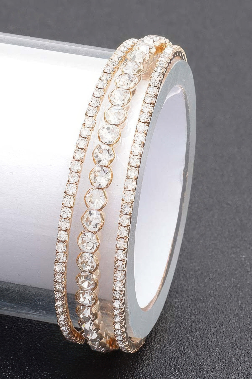 Gold-toned clear rhinestone bangle bracelet with rows of round stones