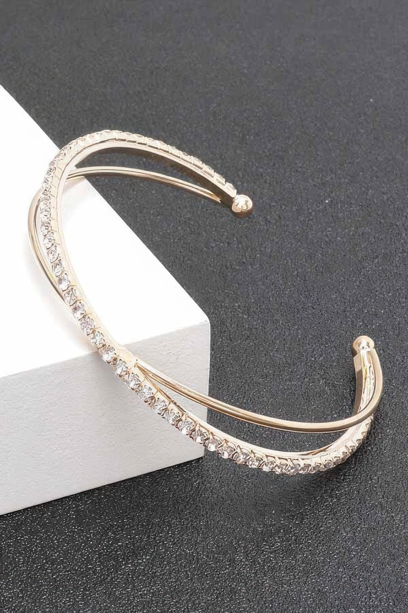 Gold clear rhinestone cuff bracelet, curved band with small stone details and hinge ends