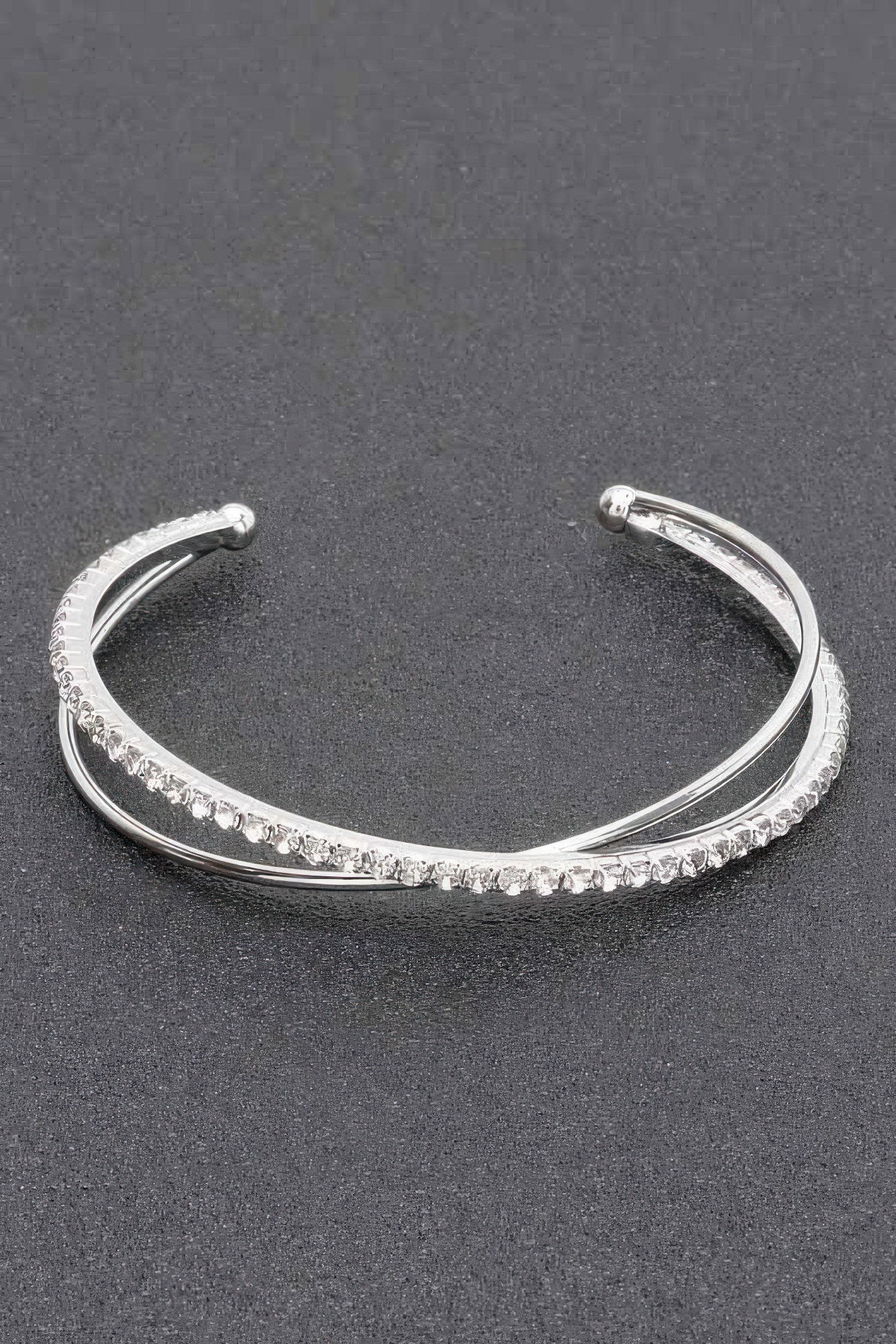 Silver-tone rhinestone cuff bracelet with a full row of faceted stones and round end caps