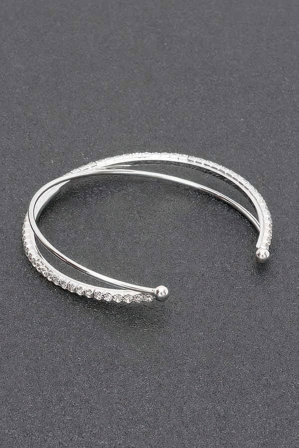 Silver clear rhinestone cuff bracelet with smooth inner band and sparkling outer stone row