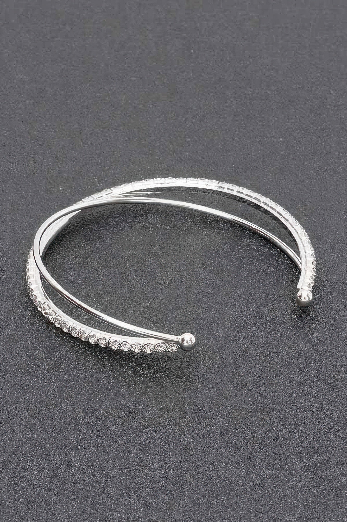 Silver clear rhinestone cuff bracelet with smooth inner band and sparkling outer stone row