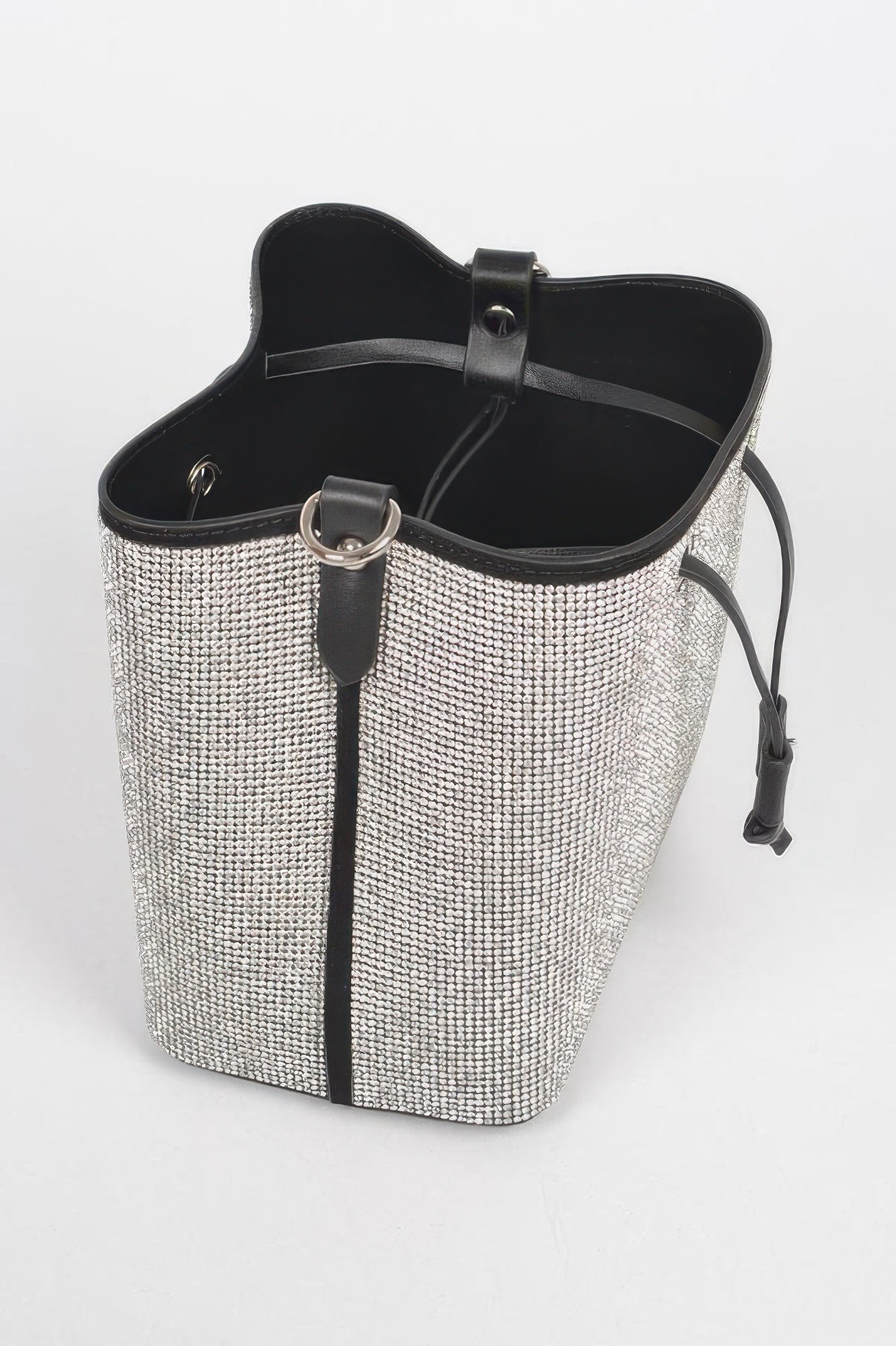 Silver rhinestone bucket bag with black top trim and interior lining