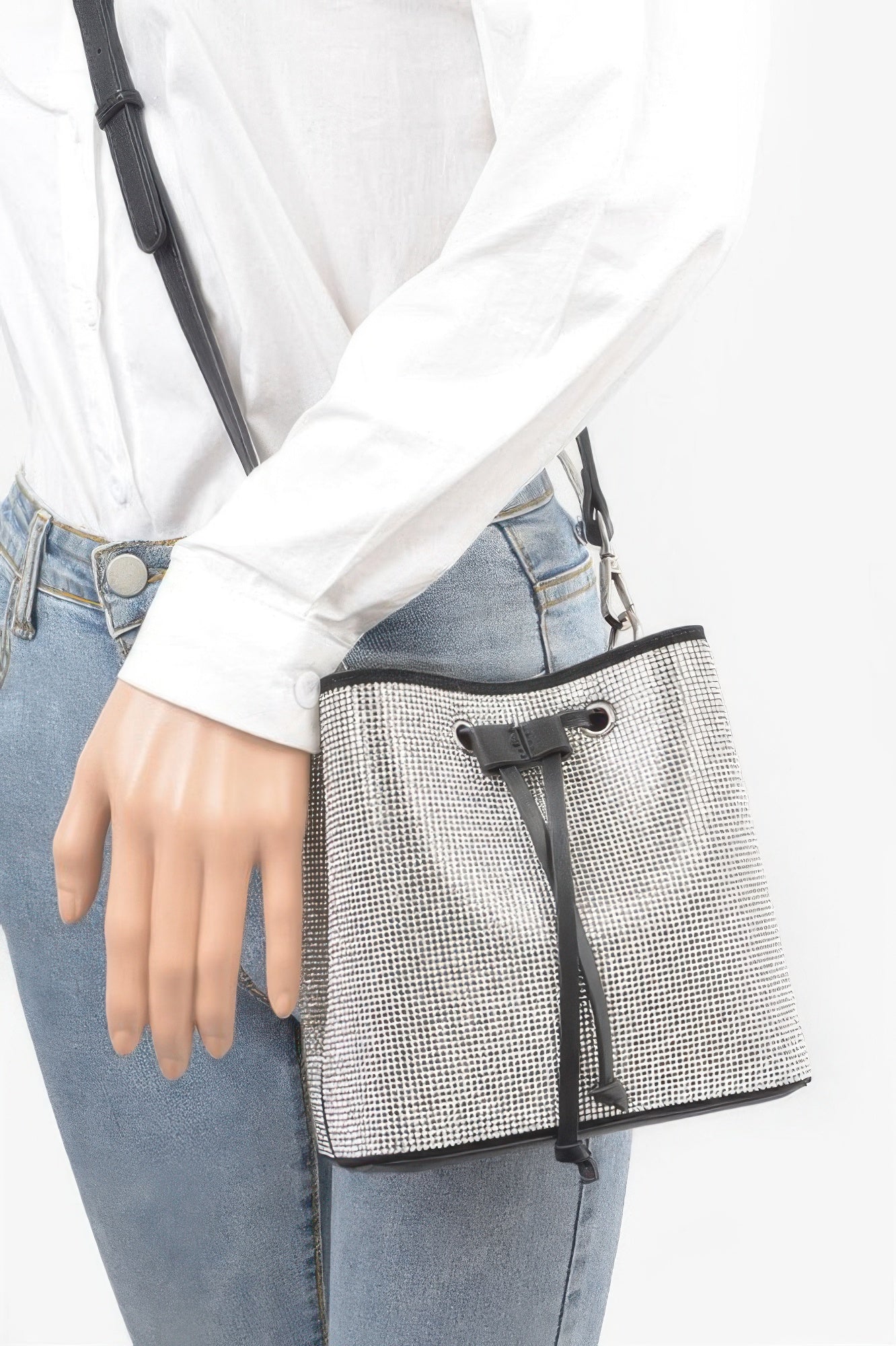Silver rhinestone bucket bag worn crossbody with black drawstring