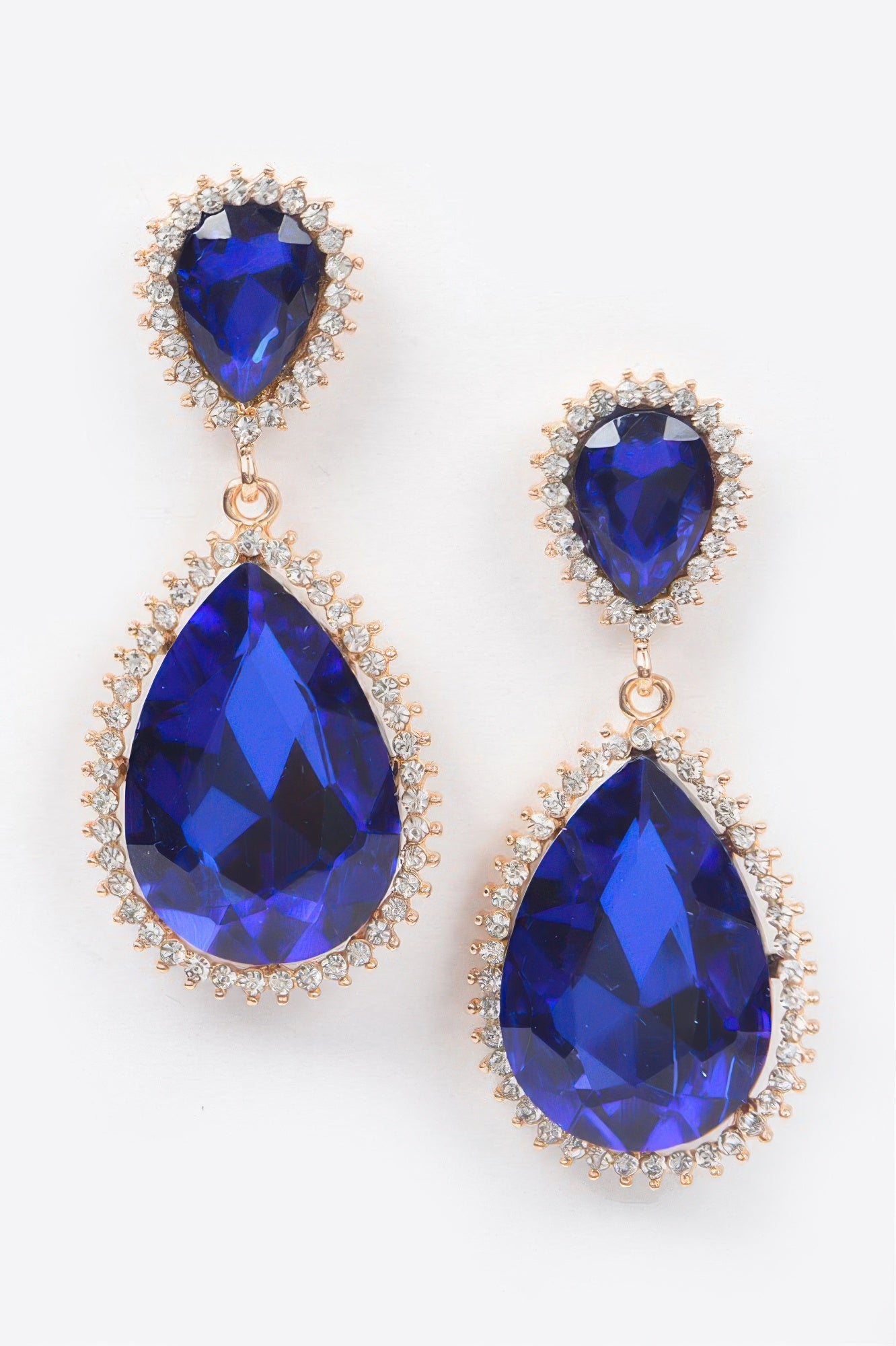 Cobalt blue rhinestone dangle earrings with gold-tone halos and teardrop drops