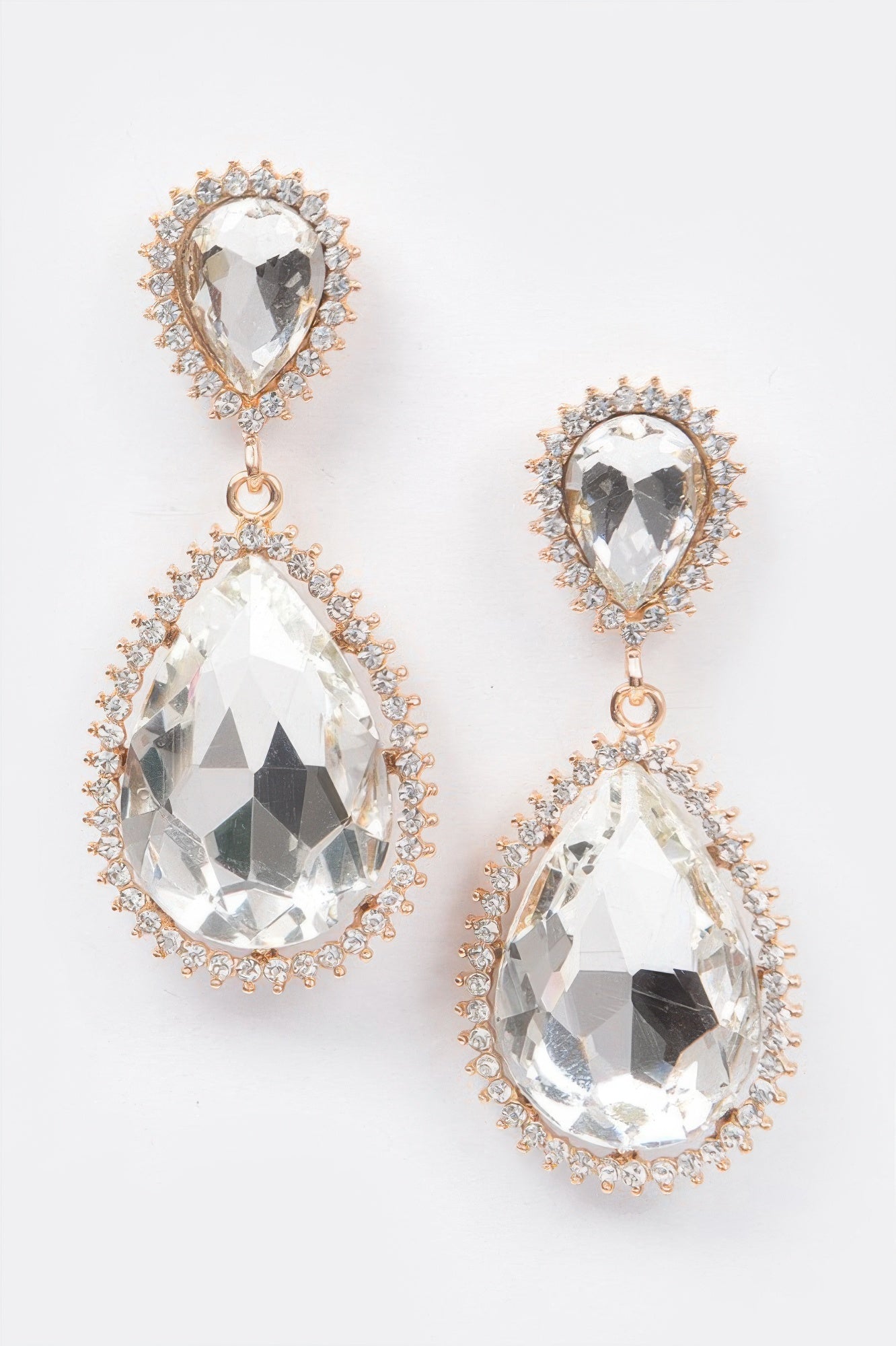 Clear rhinestone dangle earrings with gold-tone halos and teardrop drops