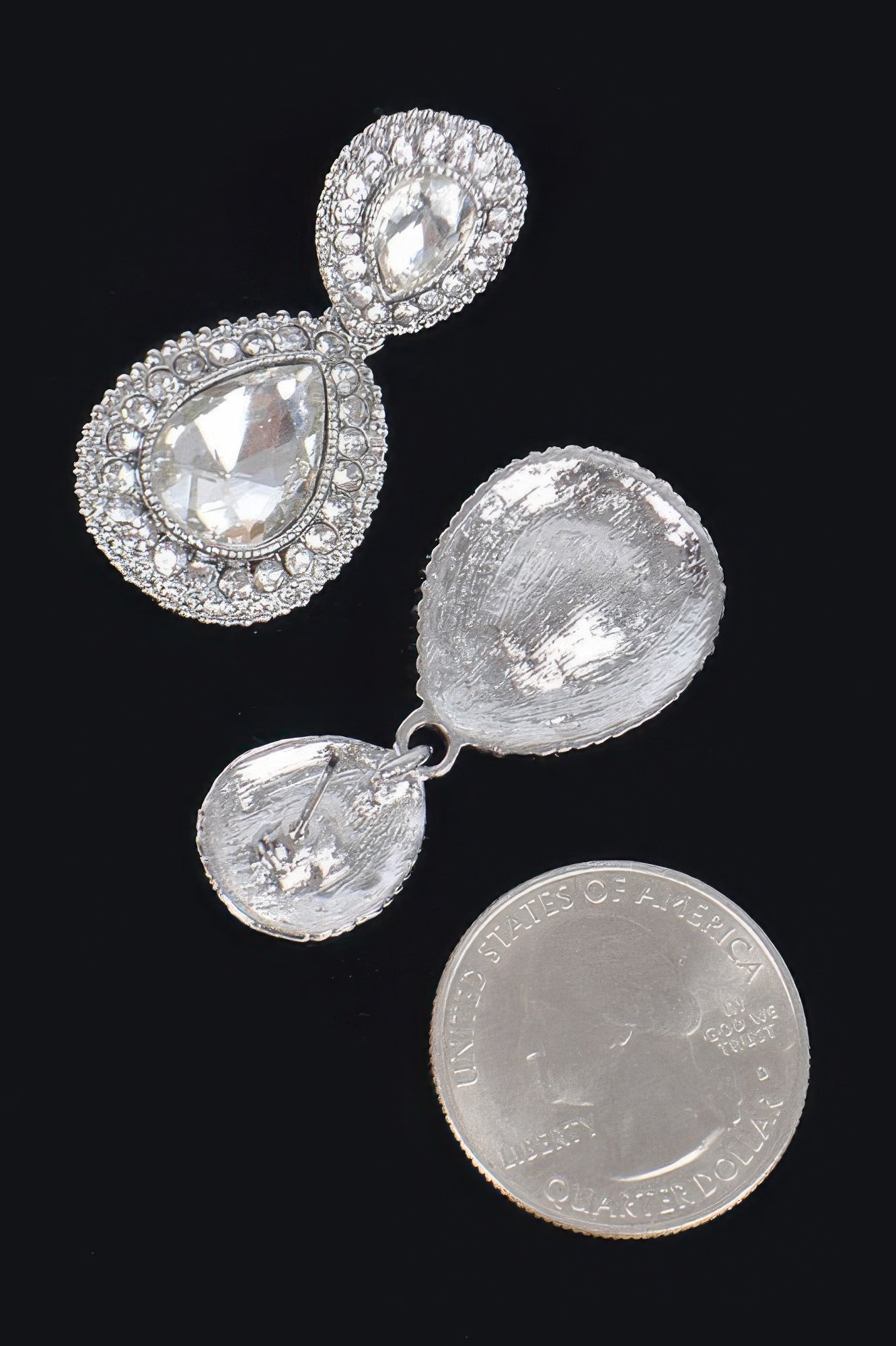 Silver-tone rhinestone dangle earrings with clear teardrop stones and textured backs