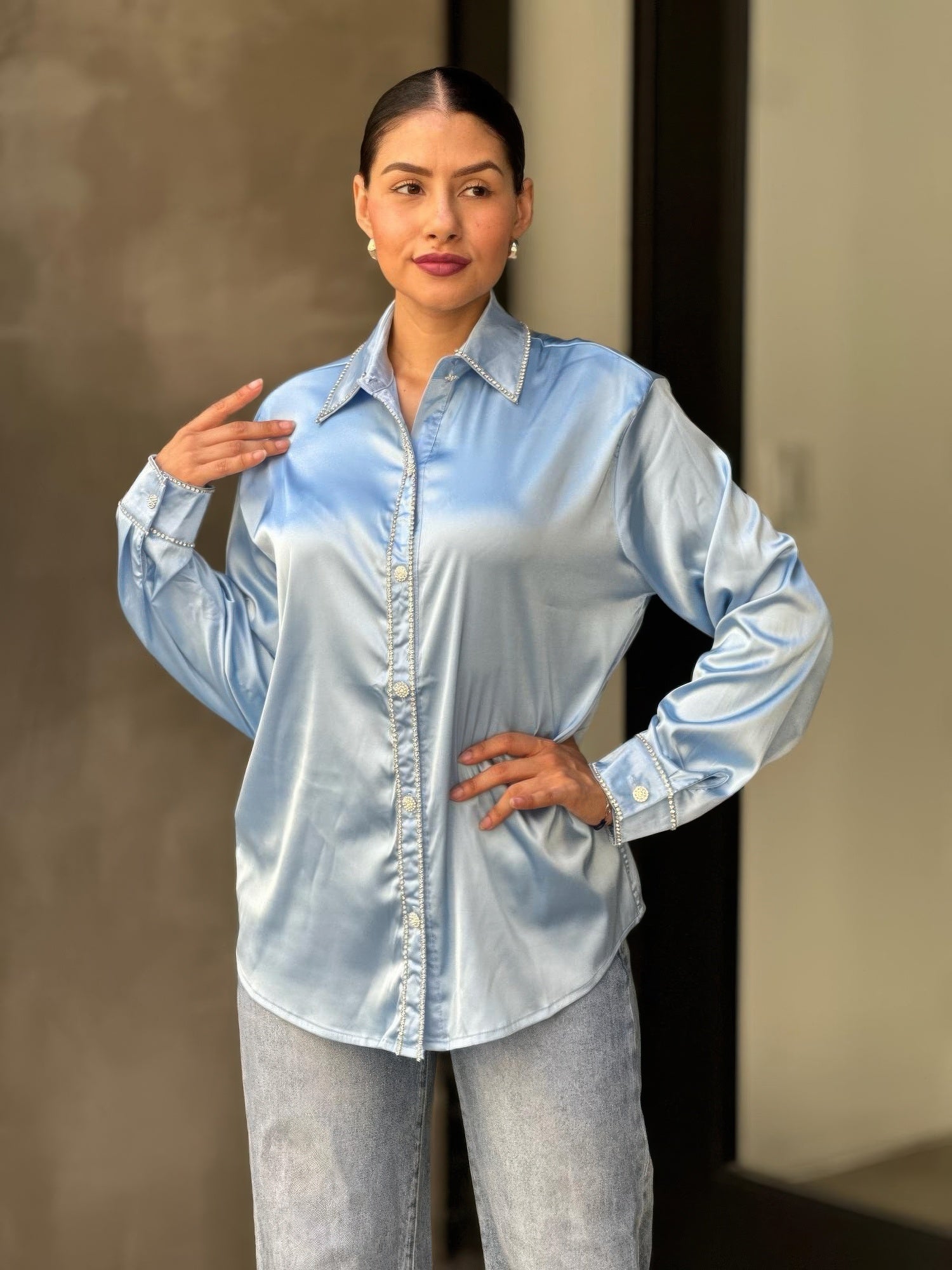 Light blue satin blouse front view: rhinestone-lined center placket, collar, cuffs