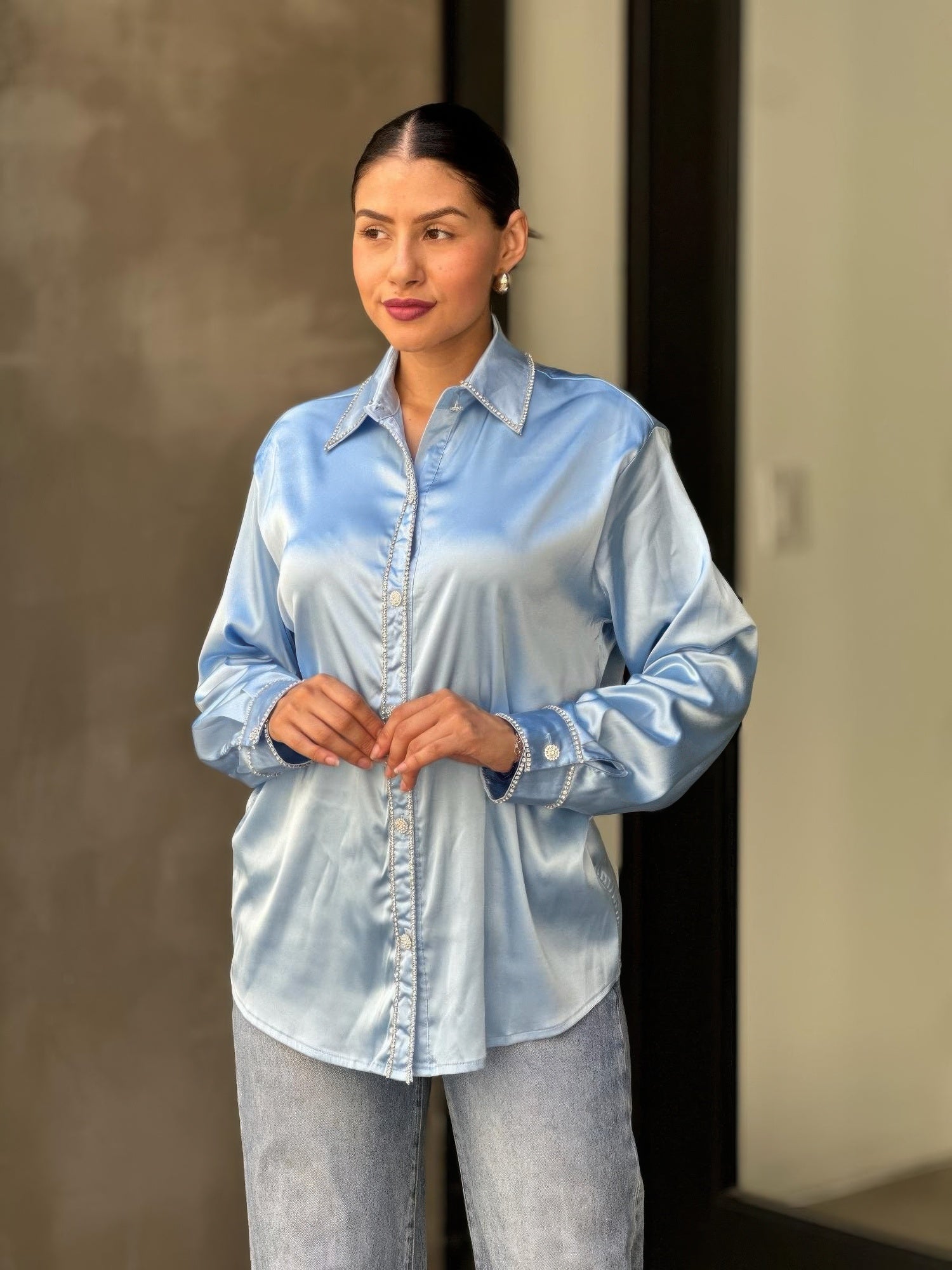 Light blue satin button-down blouse sleeve with rhinestone-trim cuff