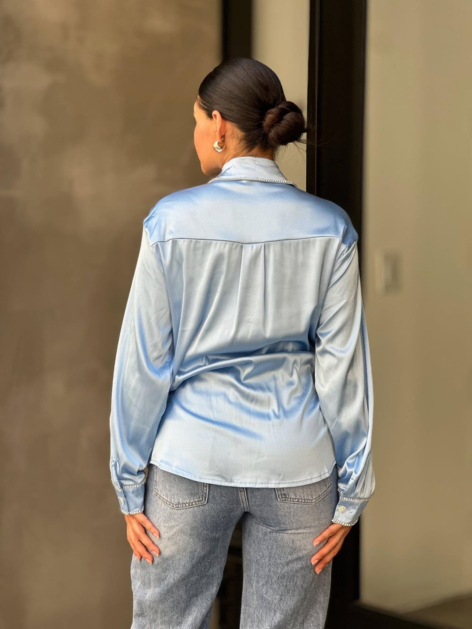 Light blue satin button-down blouse back view with smooth yoke and long sleeves