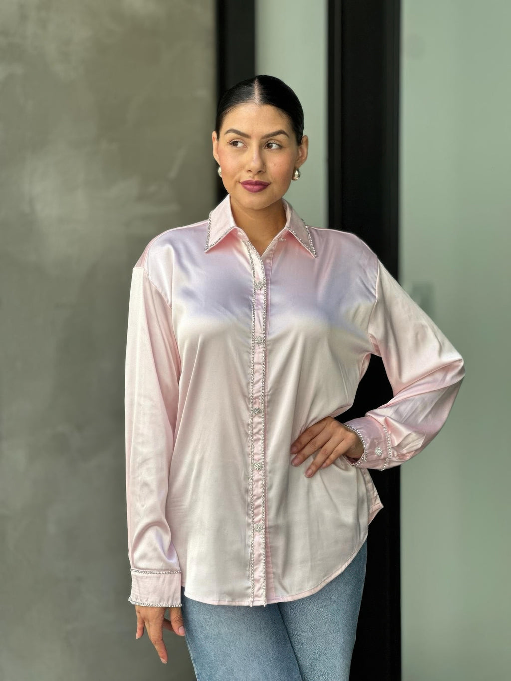 Rhinestone-lined placket and cuffs on pale pink satin button-down blouse