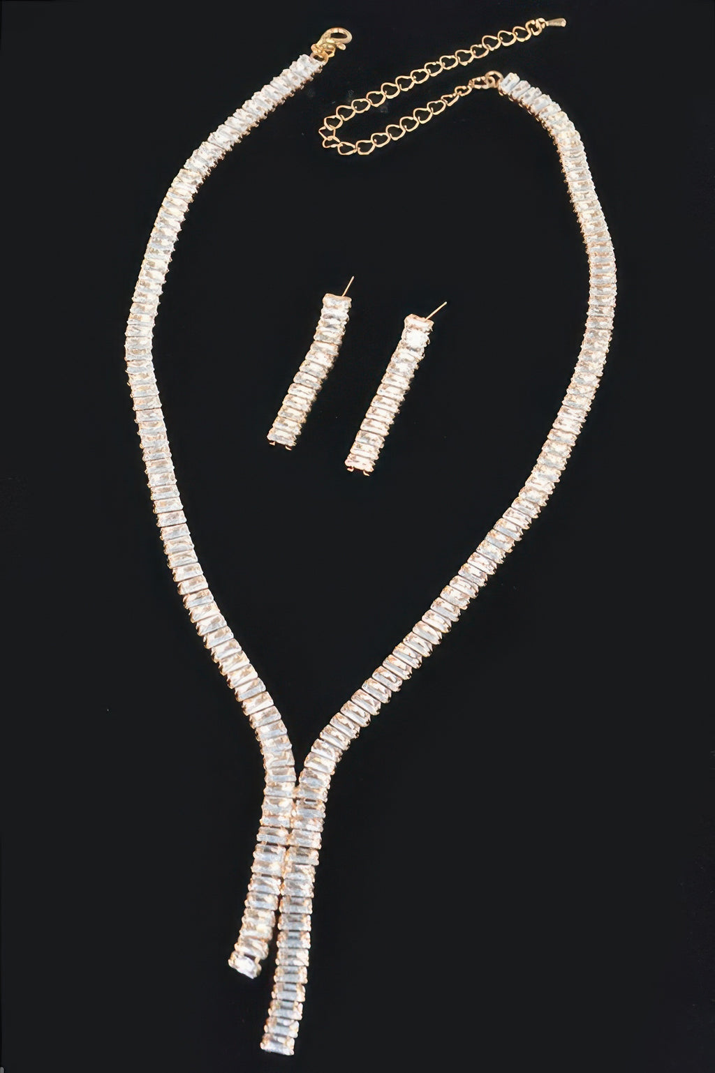 Gold rhinestone necklace with linked chain, Y-drop pendant, and rectangular stud earrings