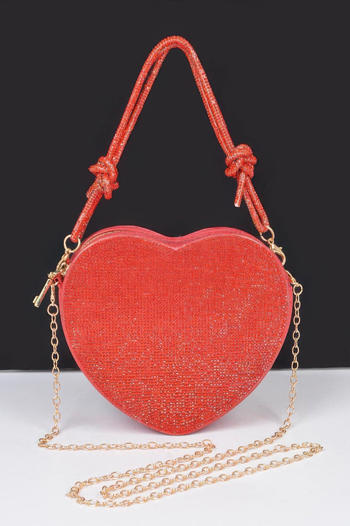 Rhinestone heart clutch bag in red with top handles and gold chain strap