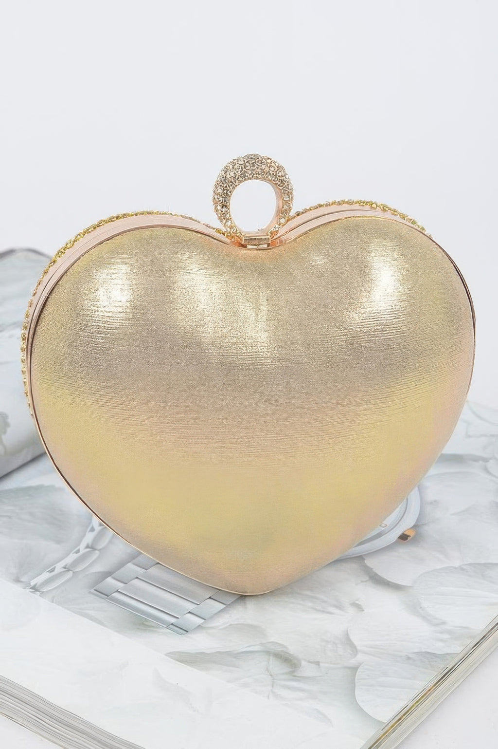 Gold heart-shaped clutch with rhinestone top ring and hinged clasp (open view)