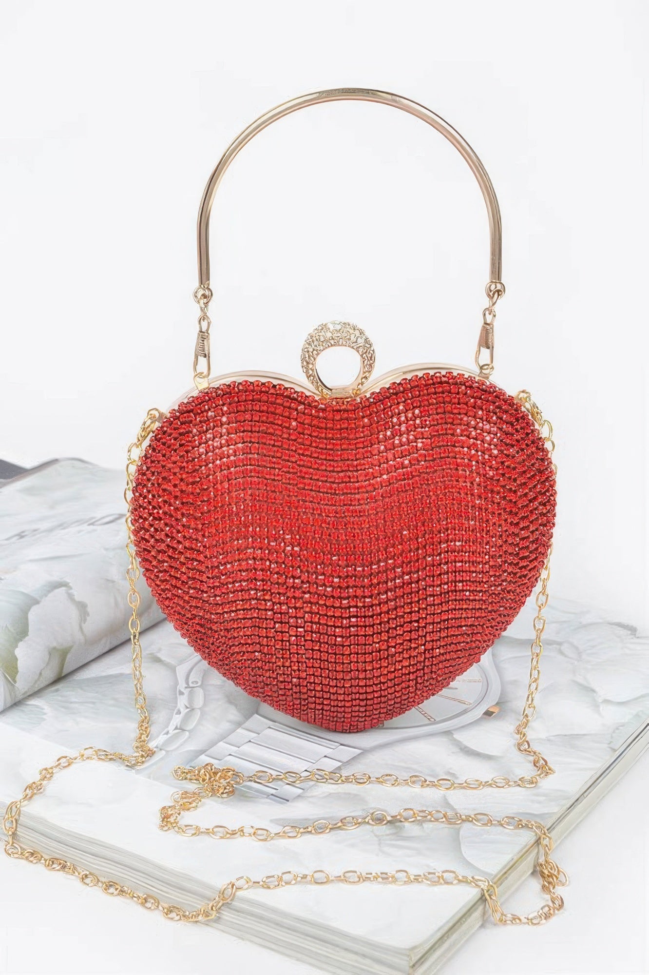 Red rhinestone heart clutch with top handle and gold-tone chain strap