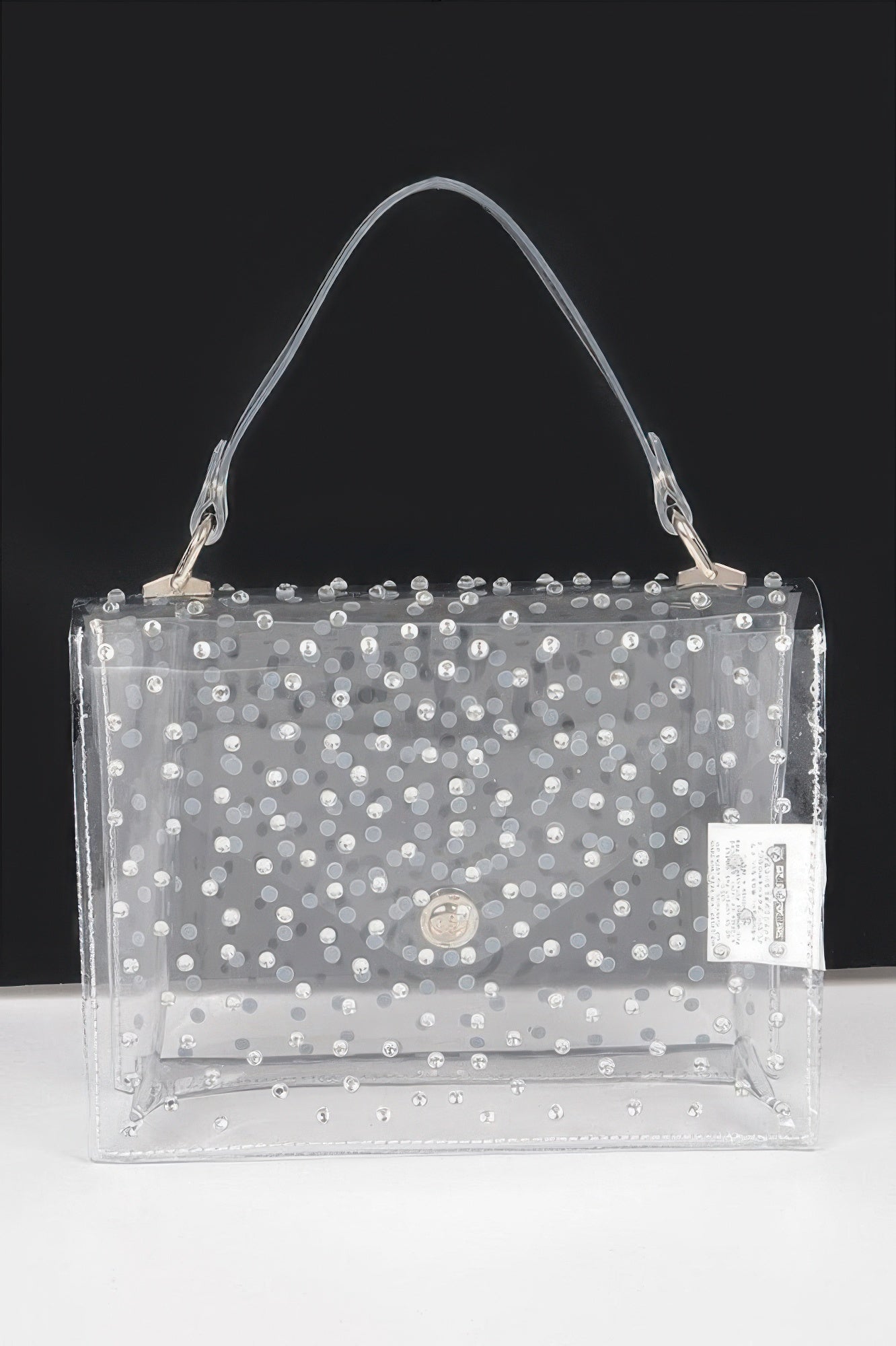 Clear silver rhinestone crossbody bag, front flap with round clasp and label pocket.
