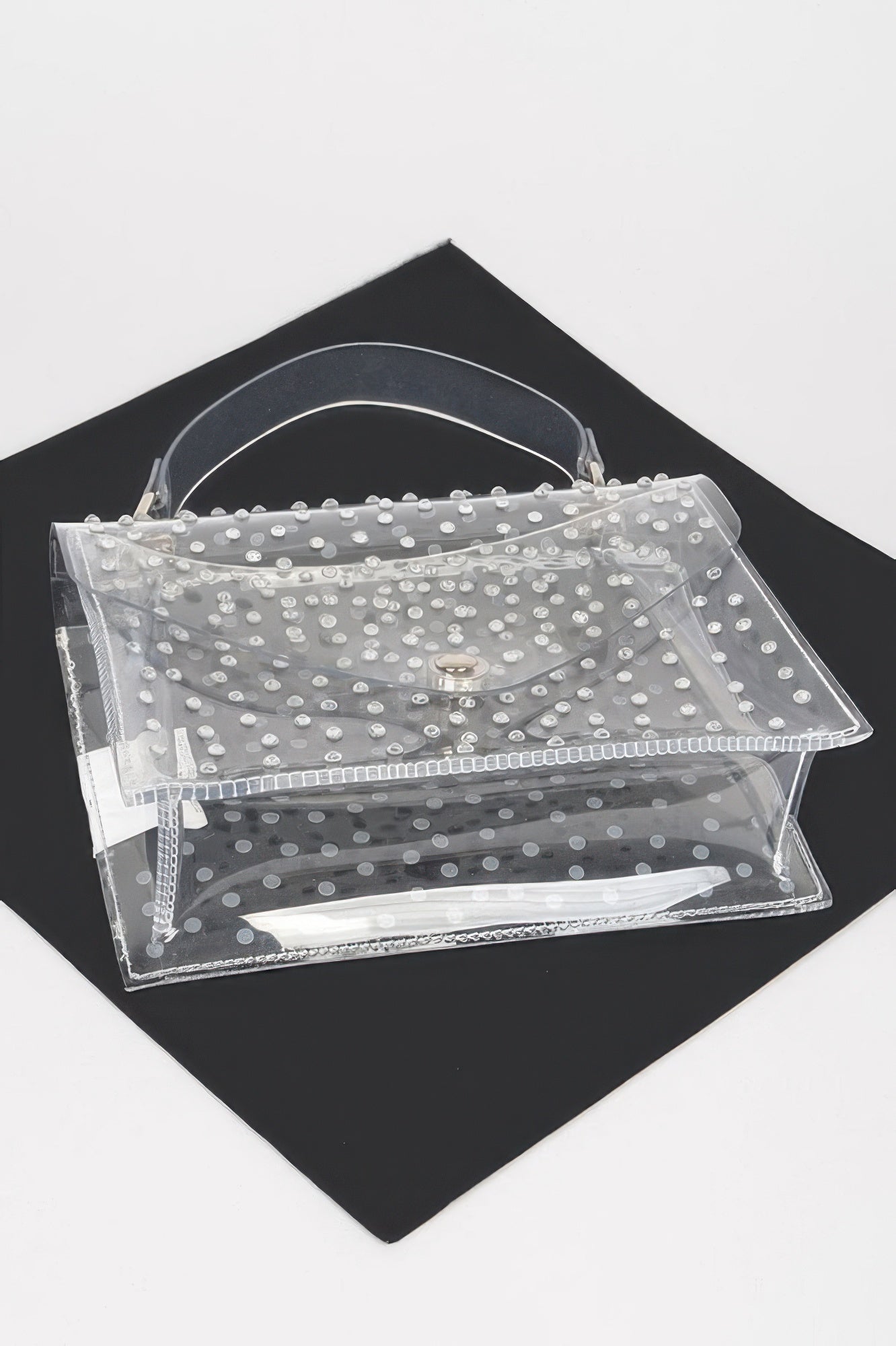 Clear silver rhinestone crossbody bag laid flat, open front flap and layered pockets.