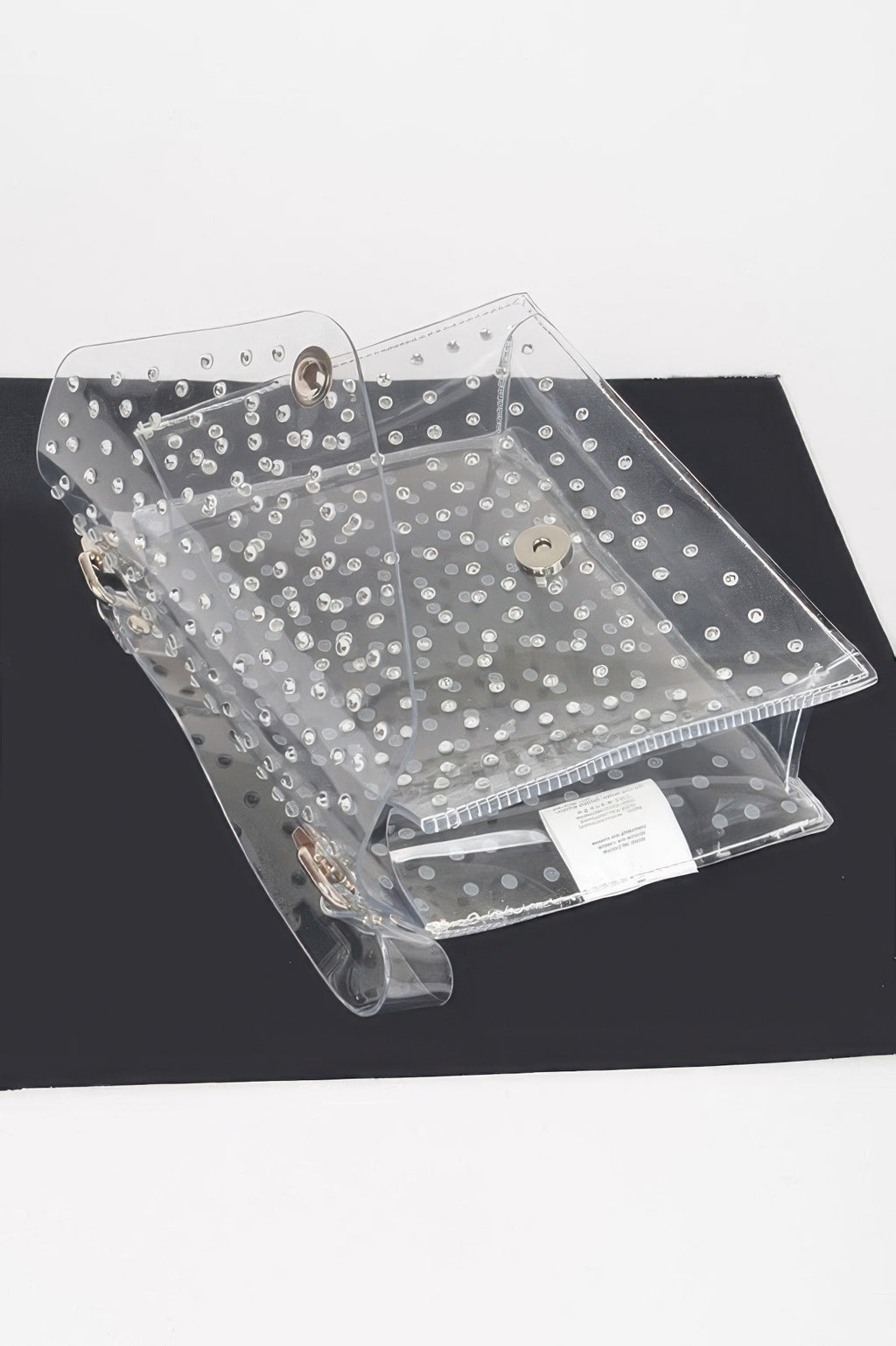 Clear silver rhinestone crossbody bag from above with front clasp and inner label.