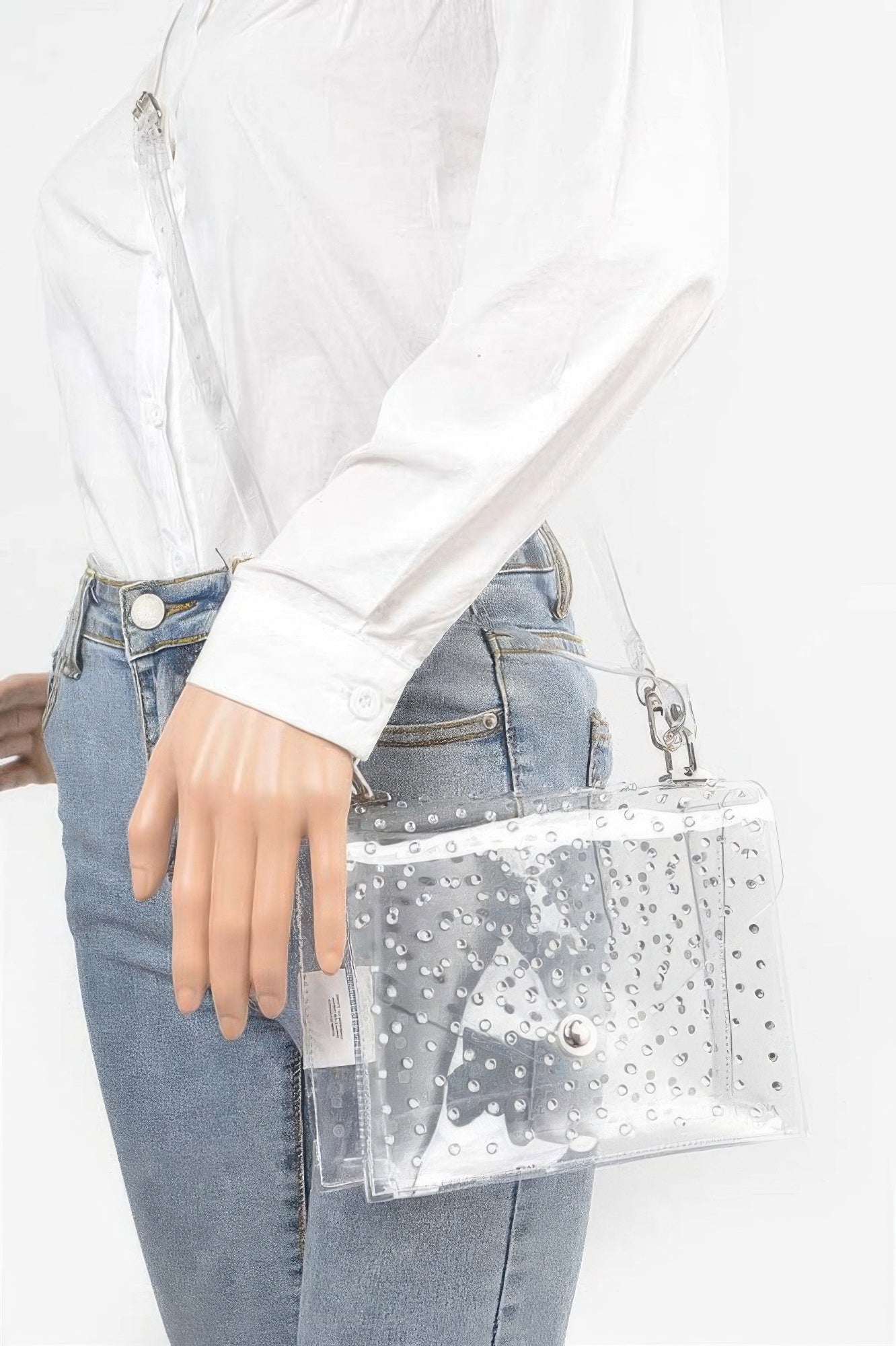 Rhinestone clear silver crossbody bag worn at hip with adjustable strap and flap front.