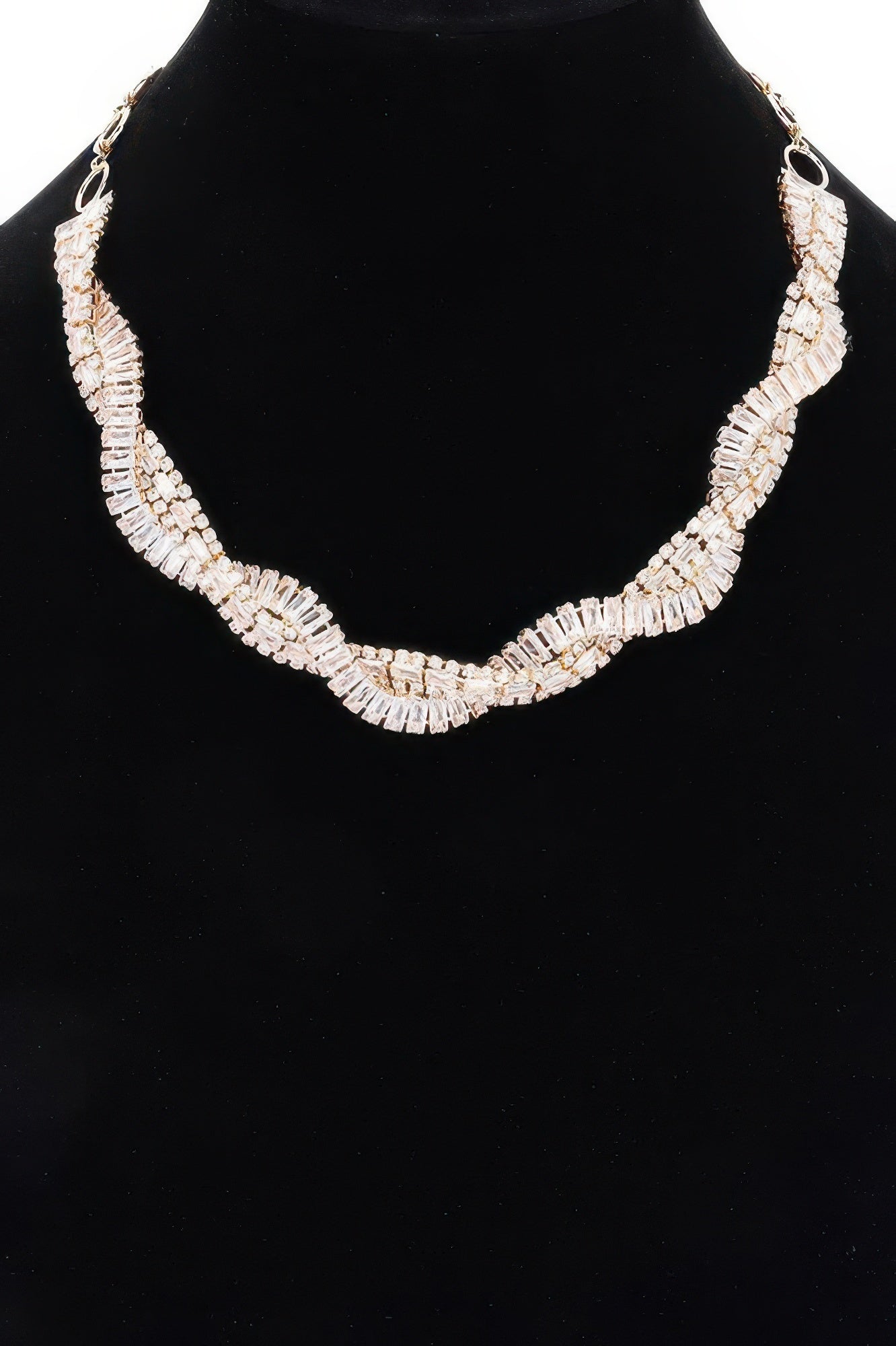 Rhinestone necklace with clear baguette stones in a curved ribbon pattern