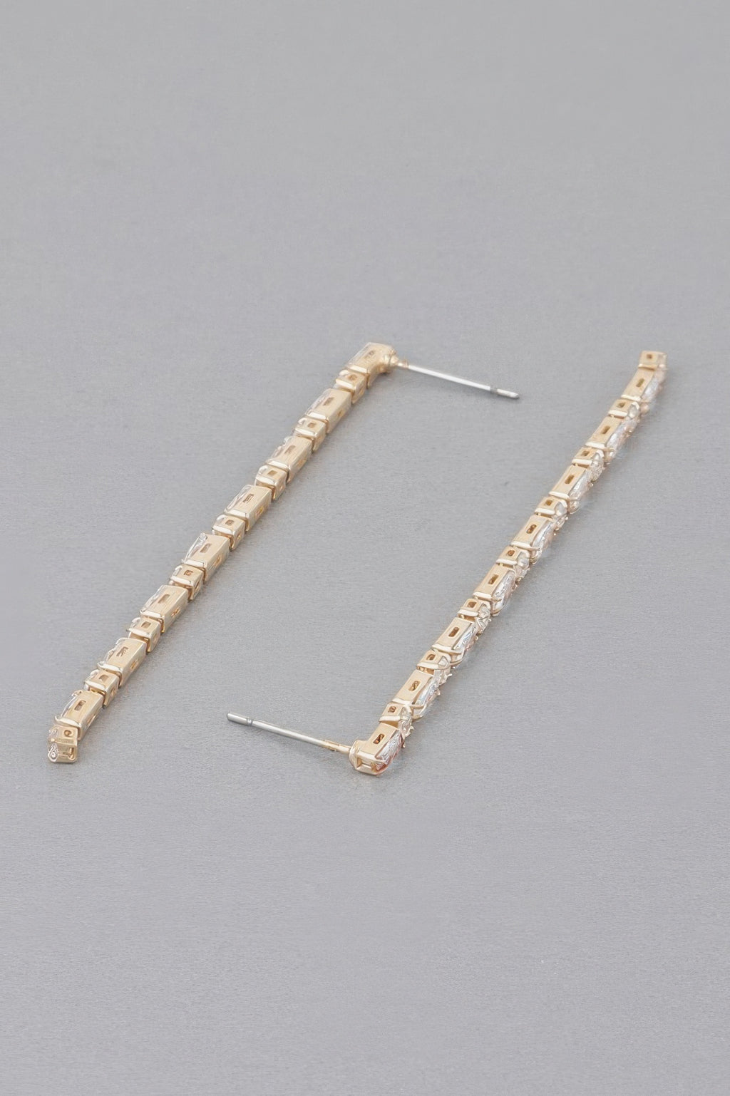 Rhinestone drop earrings in gold tone with long row of square clear stones