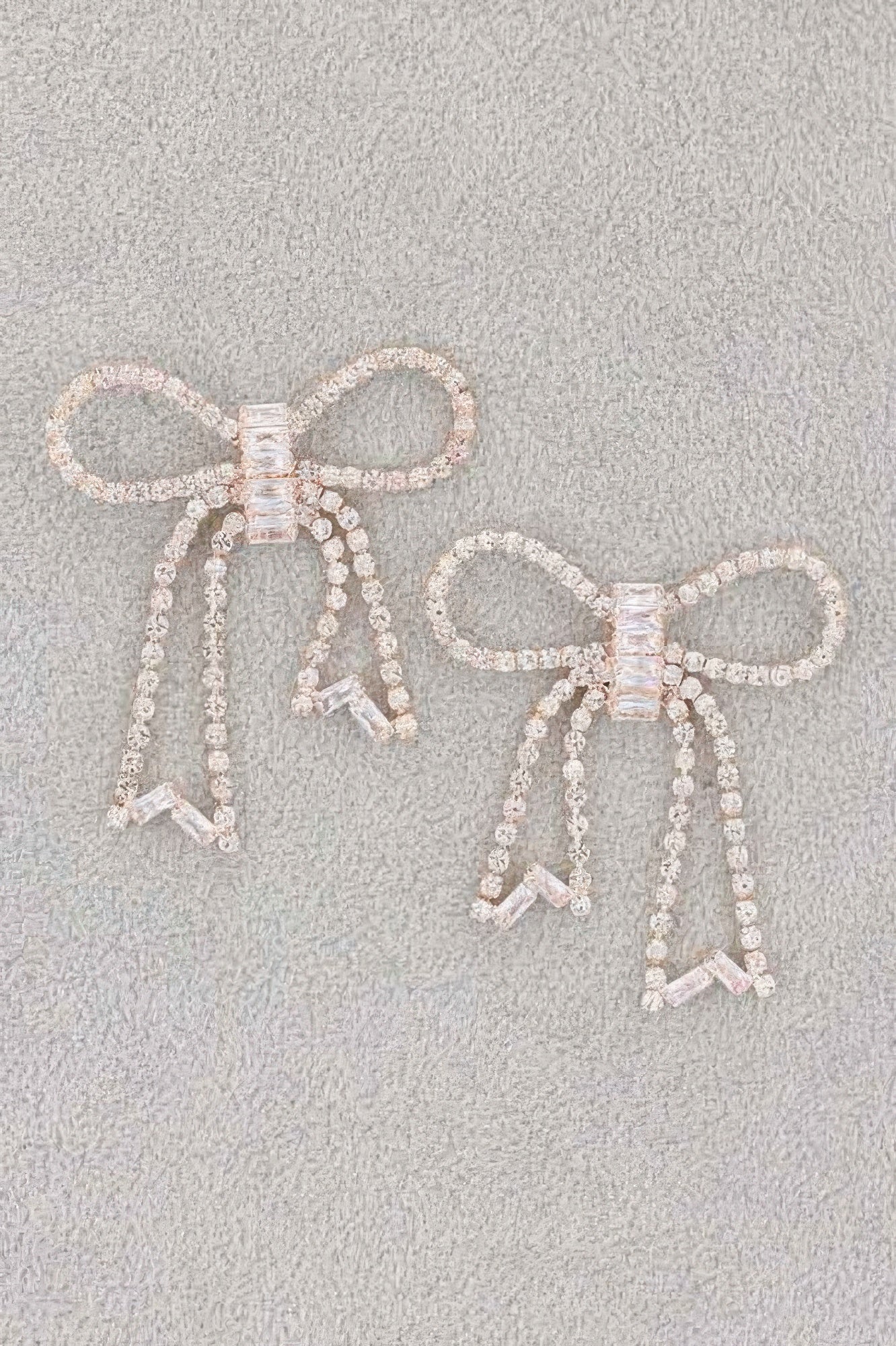 Rhinestone ribbon earrings with heart-shaped bows and dangling bead tassels, silver