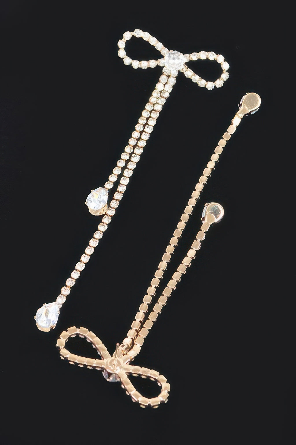 Silvertone rhinestone ribbon earrings with bow tops and long dangling strands
